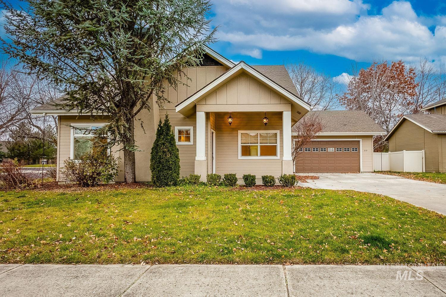 View of front of house featuring board and batten siding, covered porch, and driveway