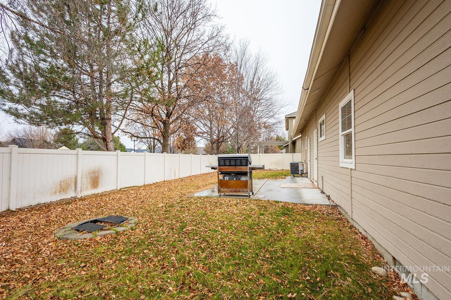 Fenced backyard with a patio