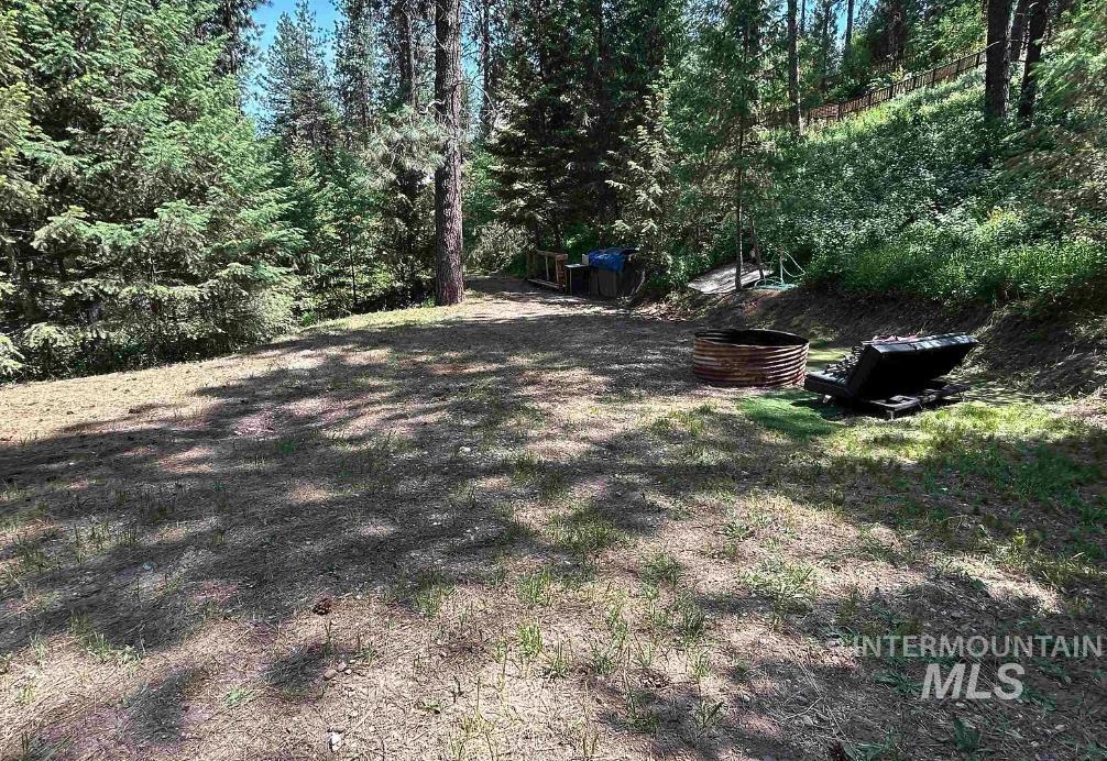 View of yard featuring a forest view
