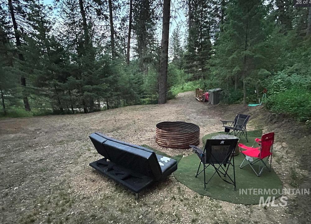 View of yard with a patio and a fire pit