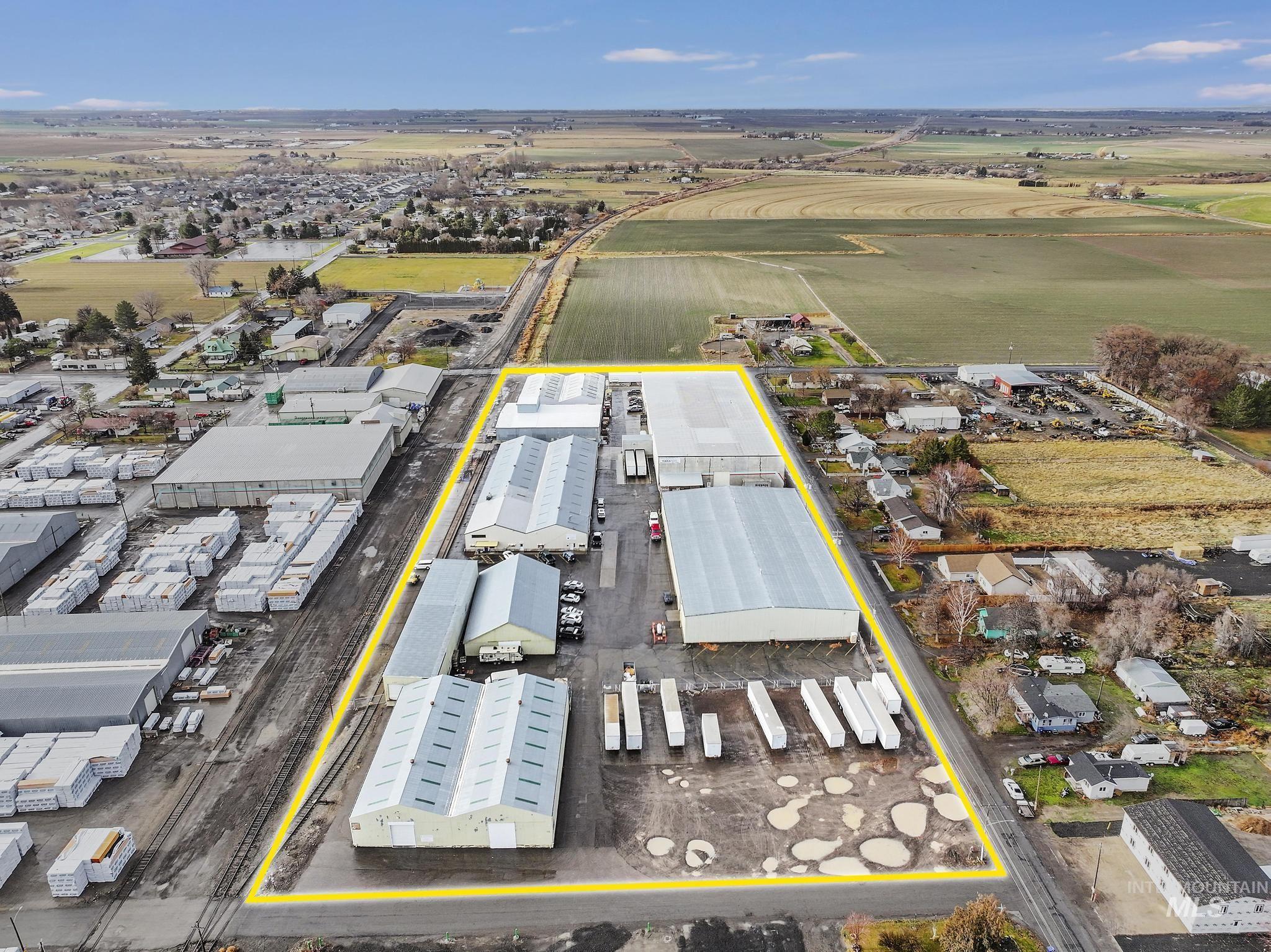 Aerial view of property and surrounding area with an industrial area and property parcel outlined