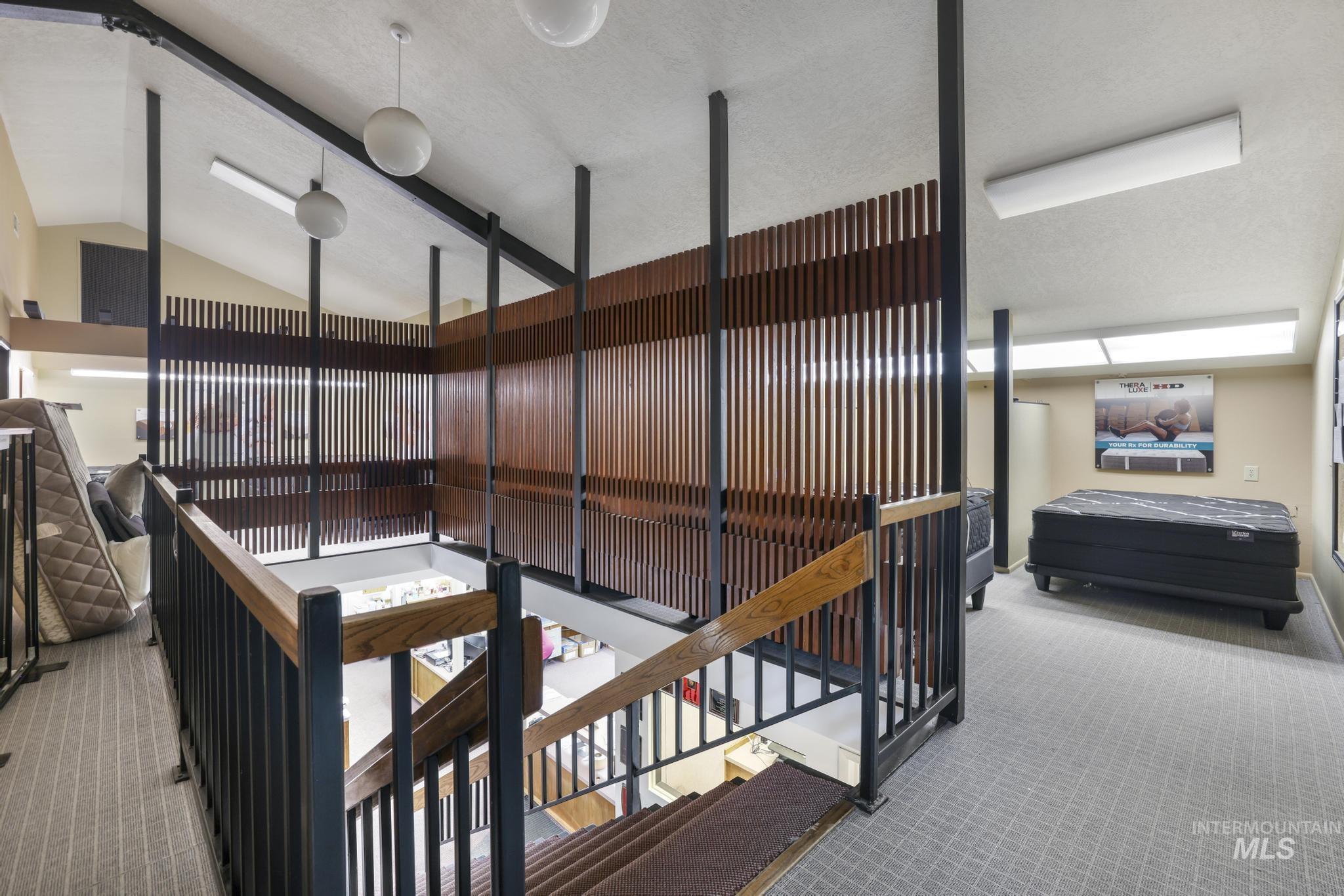 Hall featuring carpet and vaulted ceiling