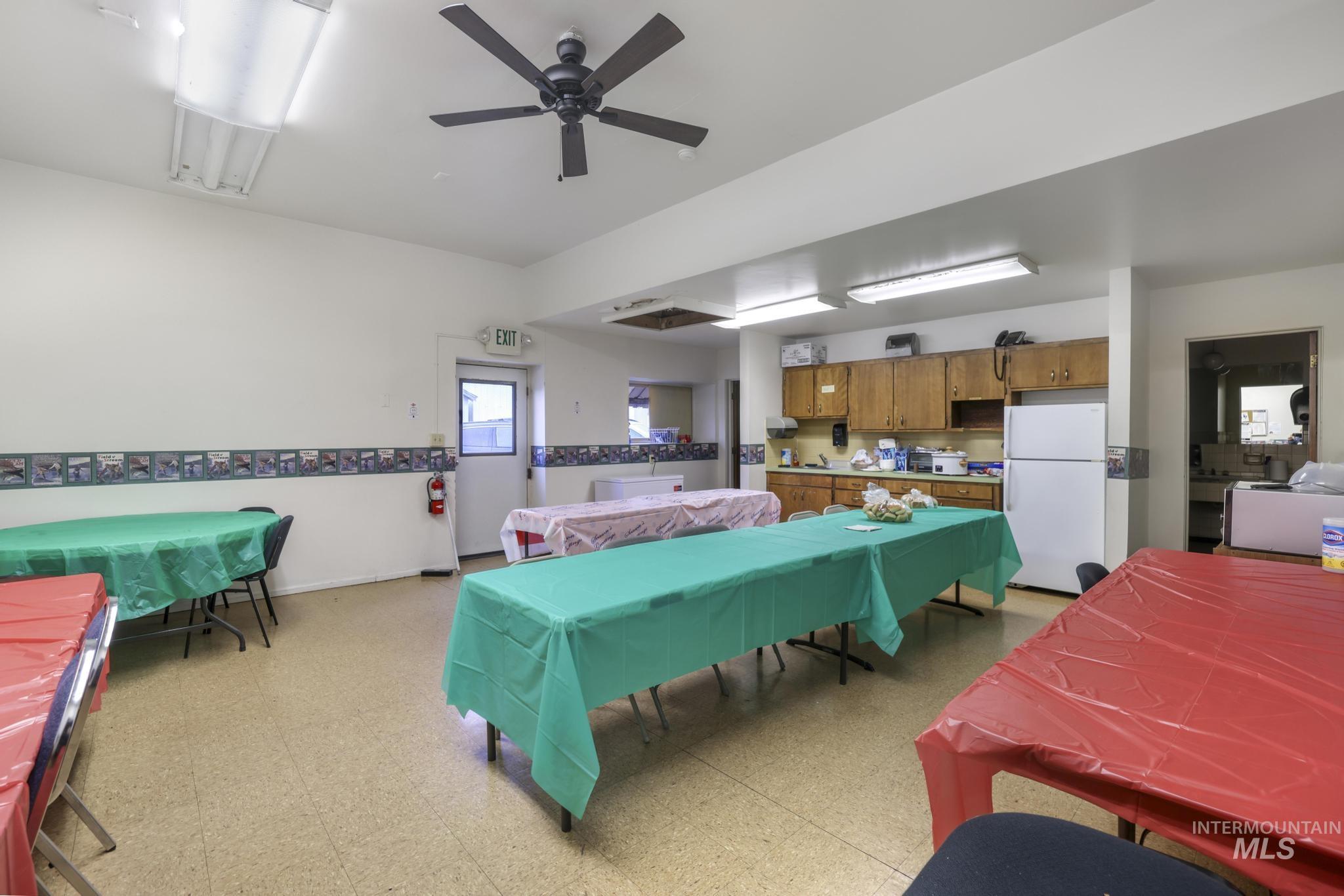 Dining space with light flooring, a ceiling fan, and washer / clothes dryer