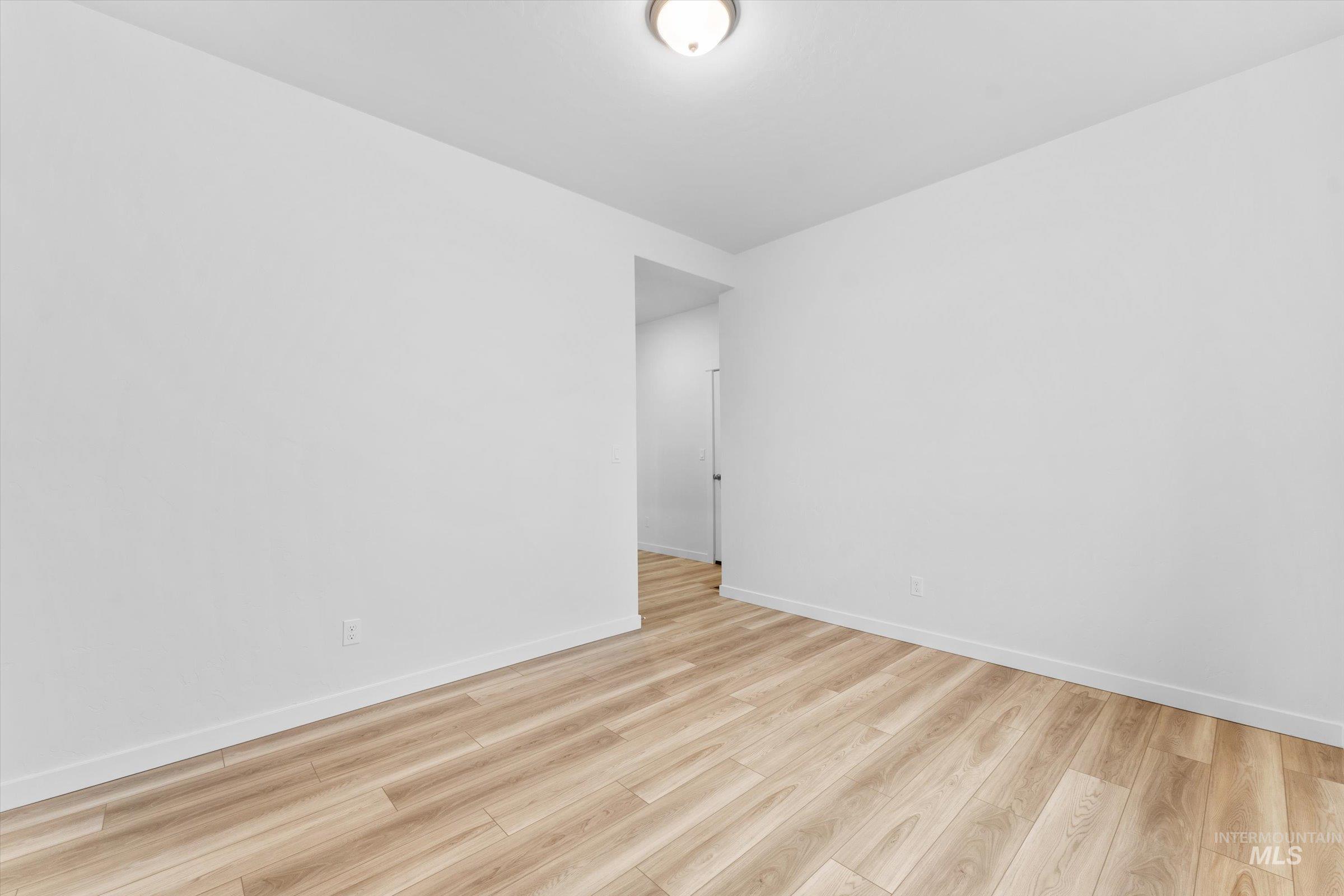 Spare room with light wood finished floors and baseboards