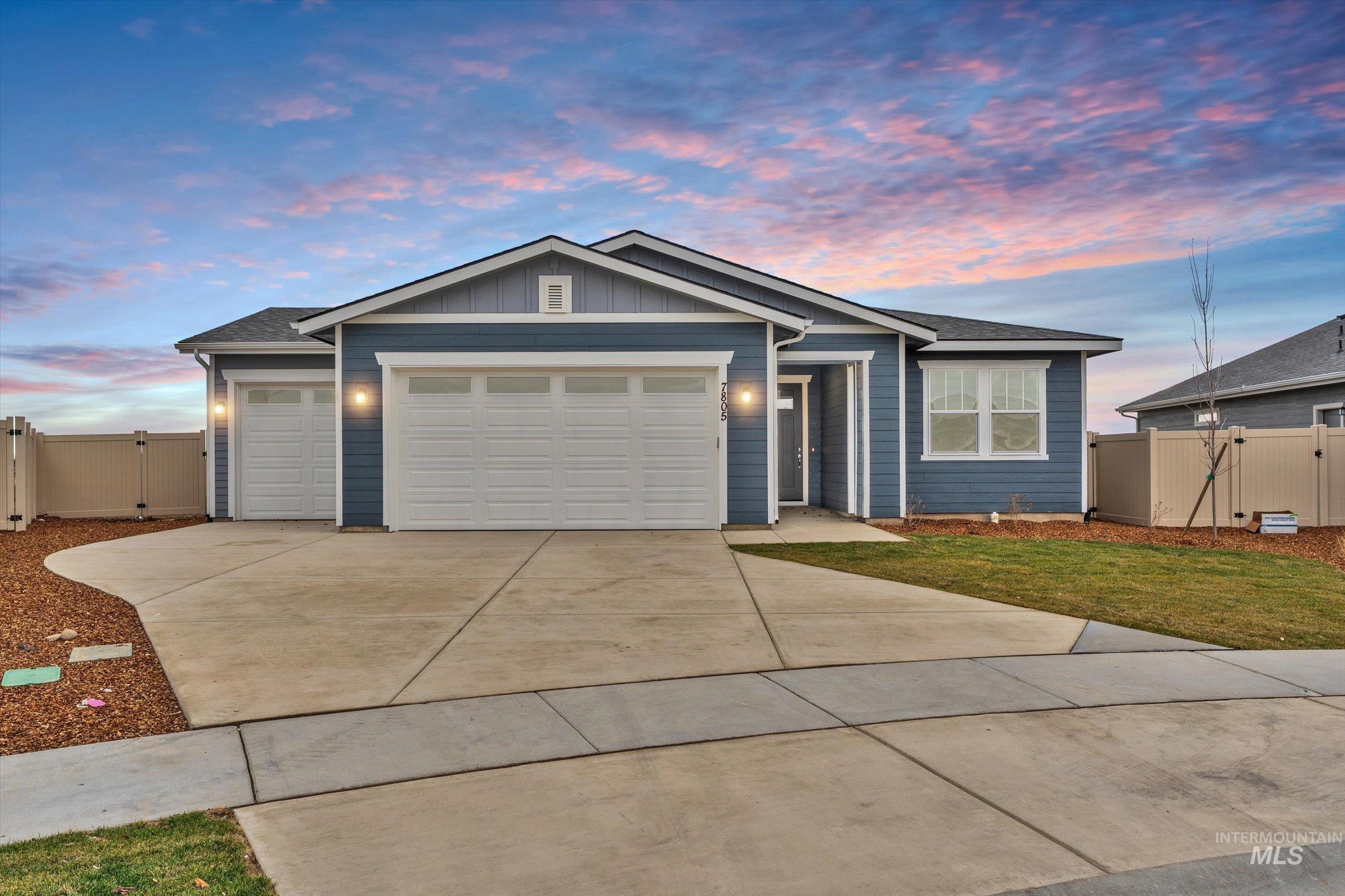 Single story home with board and batten siding, a gate, concrete driveway, a garage, and roof with shingles