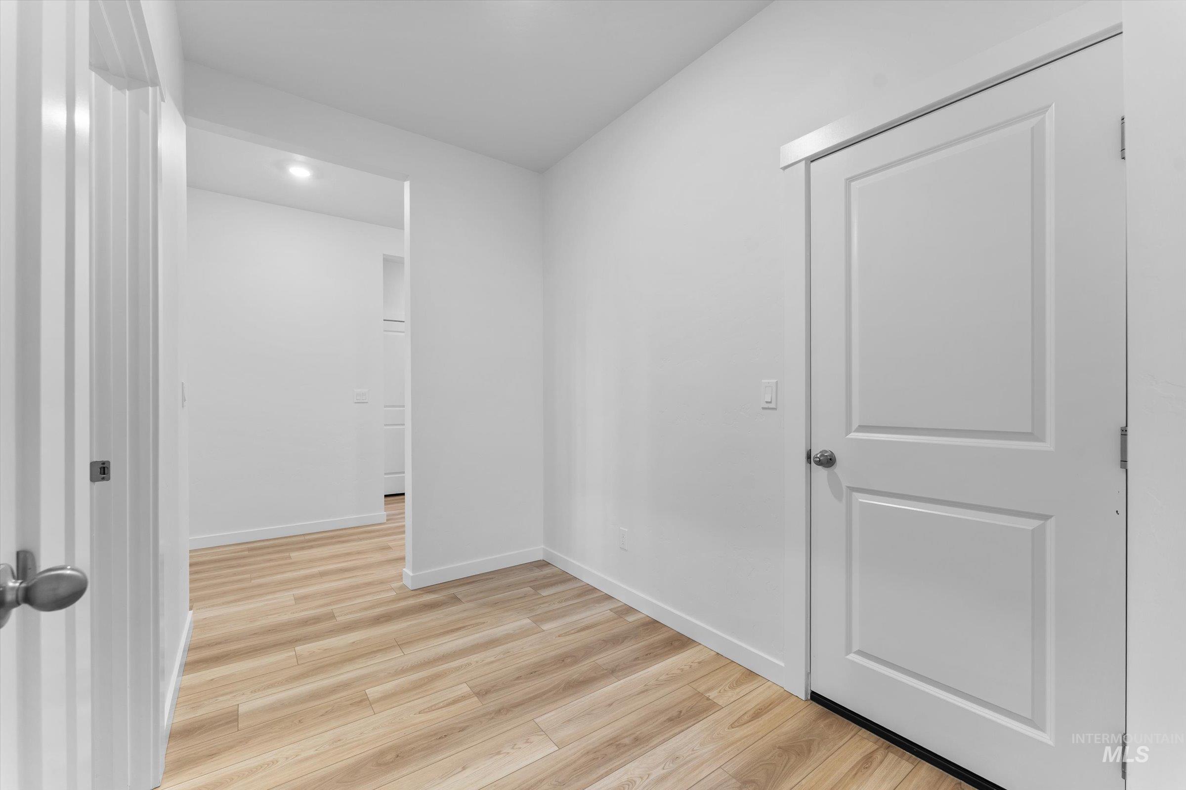 Unfurnished room with light wood finished floors and recessed lighting