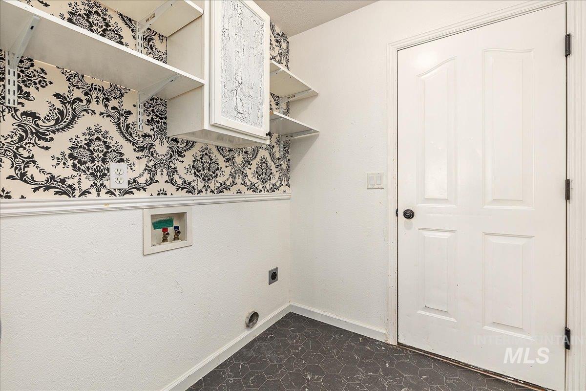 Washroom with washer hookup, electric dryer hookup, and dark floors