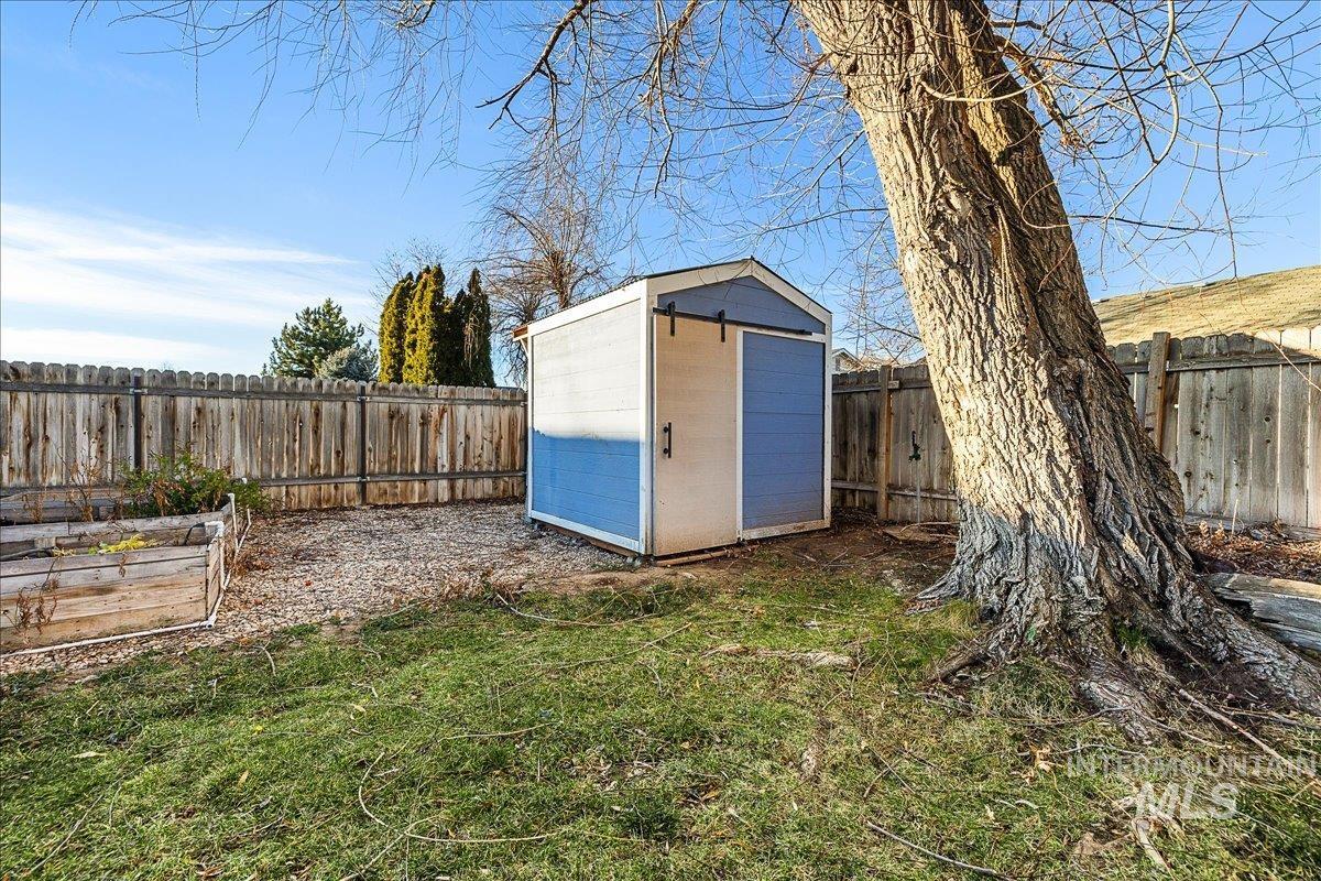View of shed featuring a fenced backyard