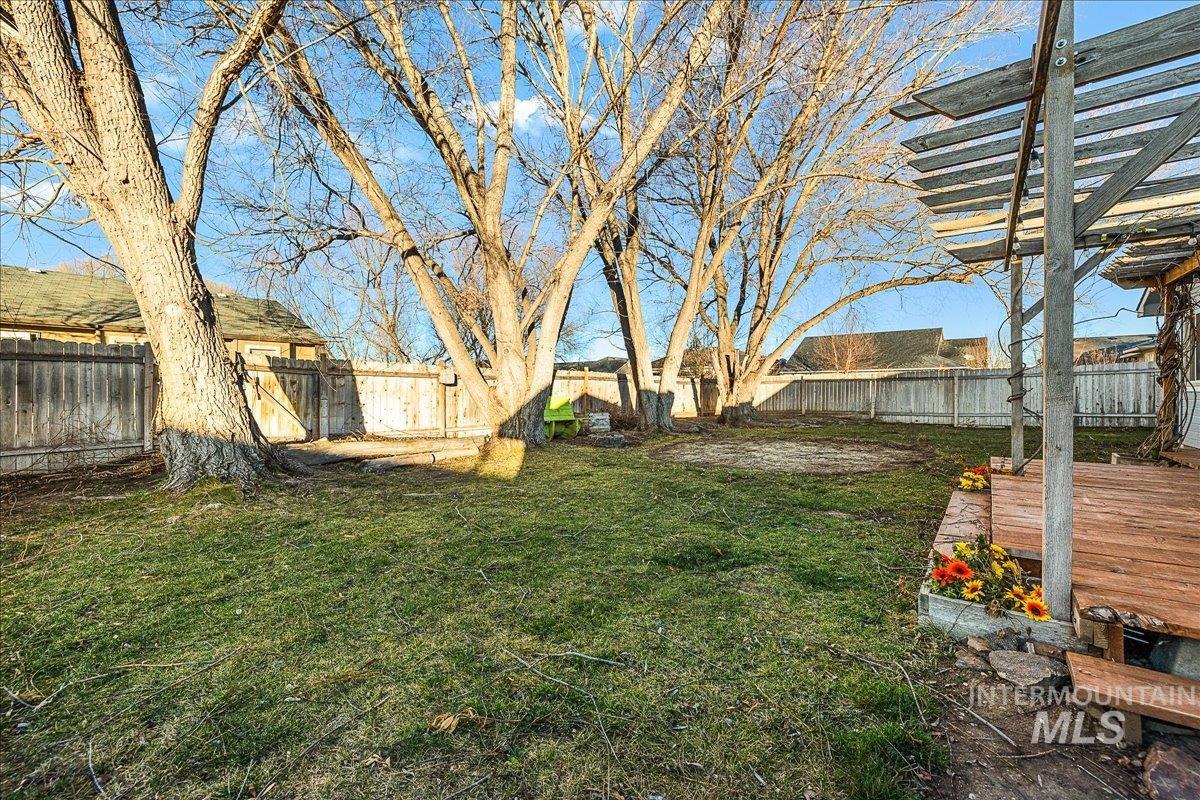 Fenced backyard with a deck