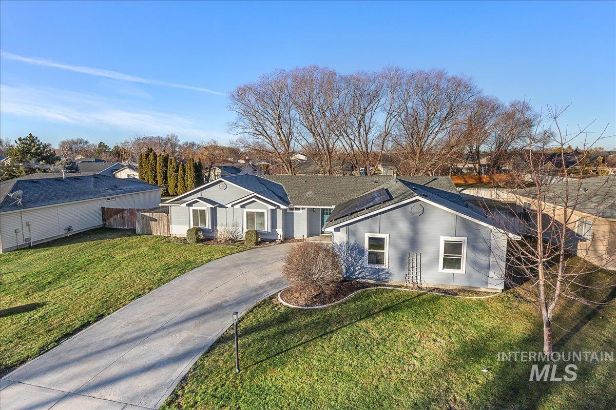 Single story home featuring a residential view and concrete driveway