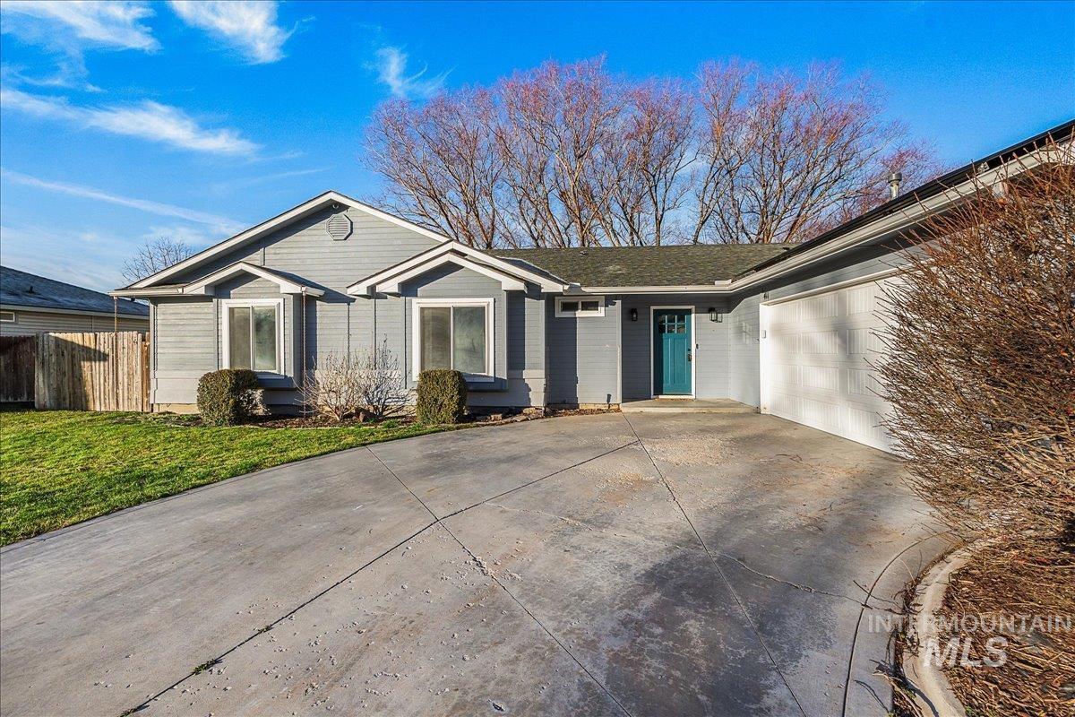 Ranch-style house with driveway and a garage
