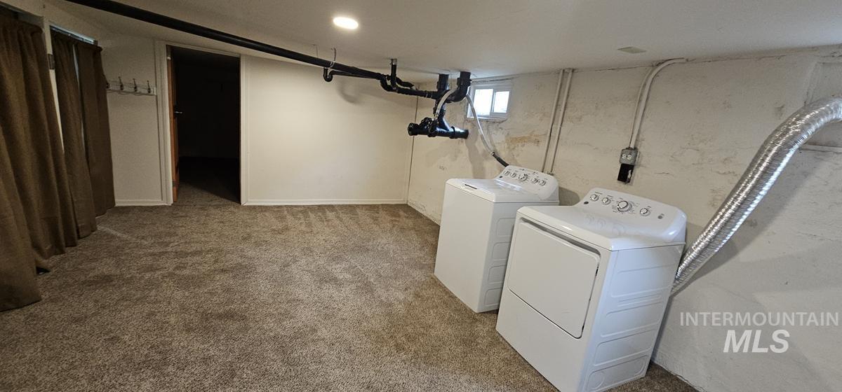 Washroom with washer and dryer and carpet flooring