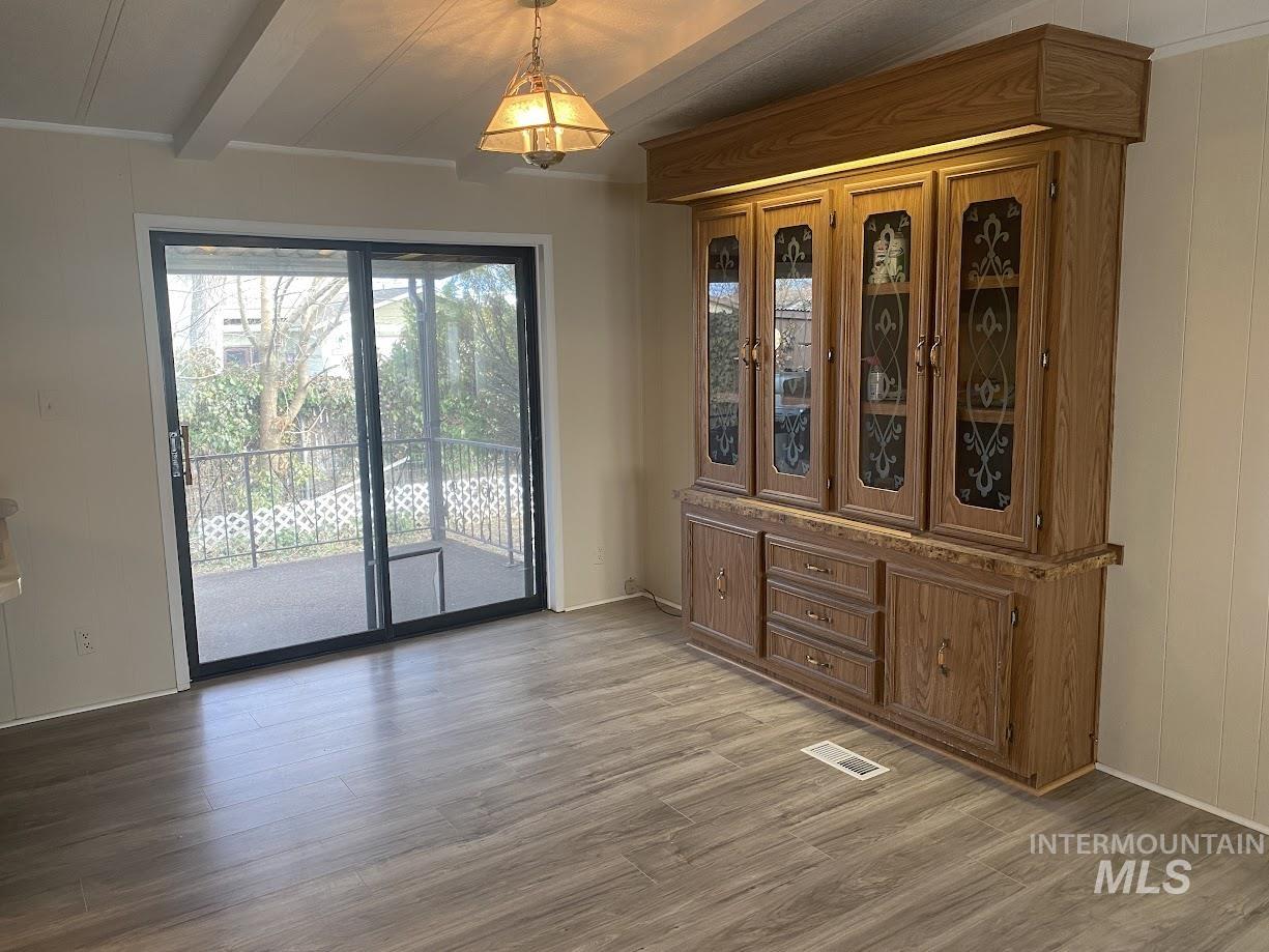Dining area featuring light wood-type flooring and built-in hutch.