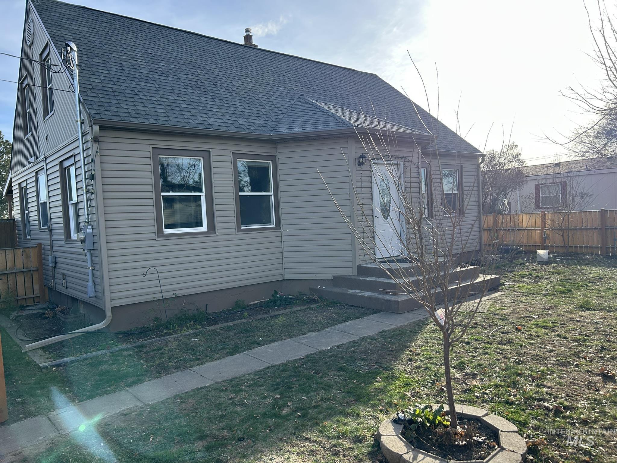 View of front of house featuring roof with shingles