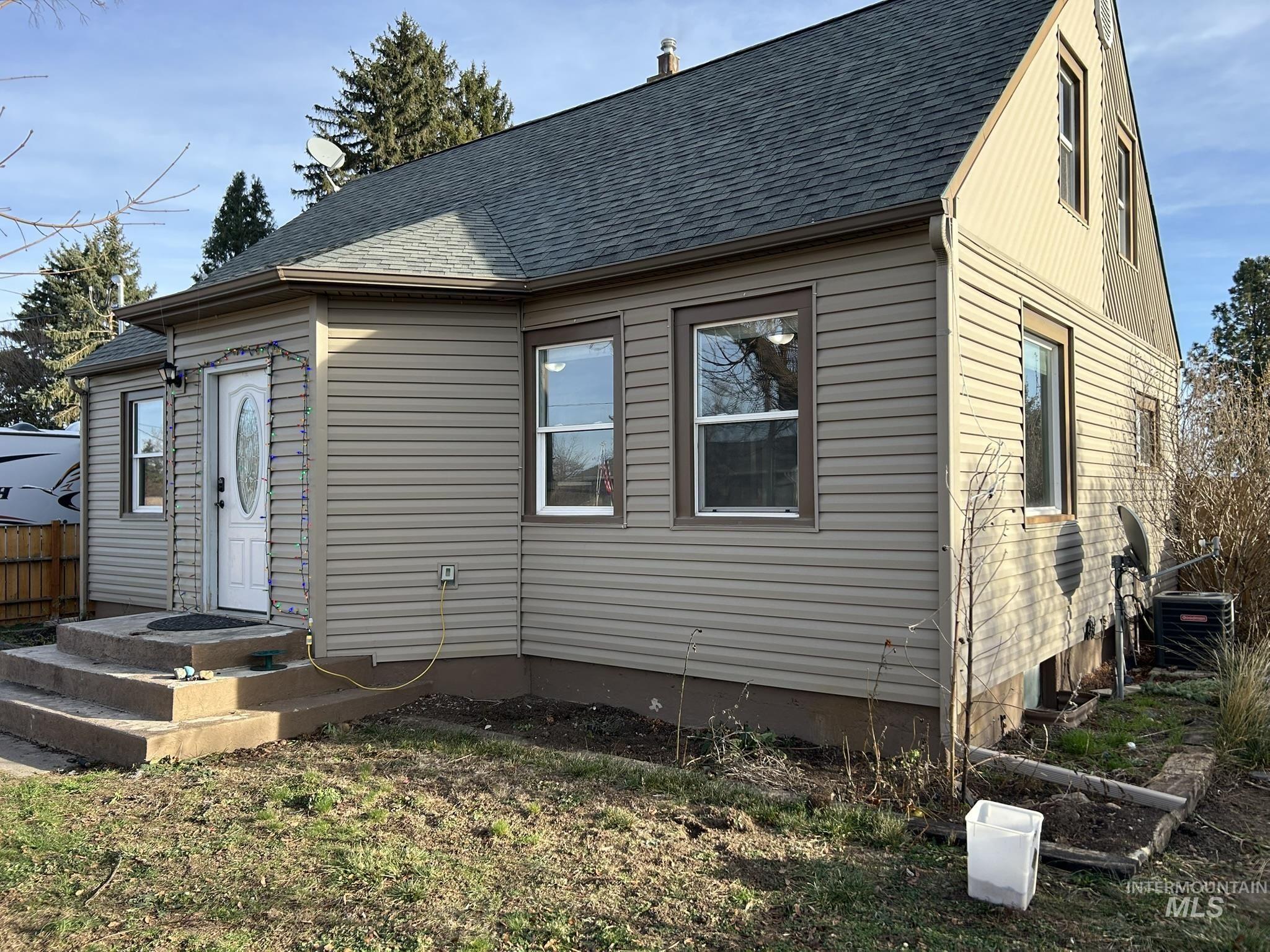 View of front facade with roof with shingles
