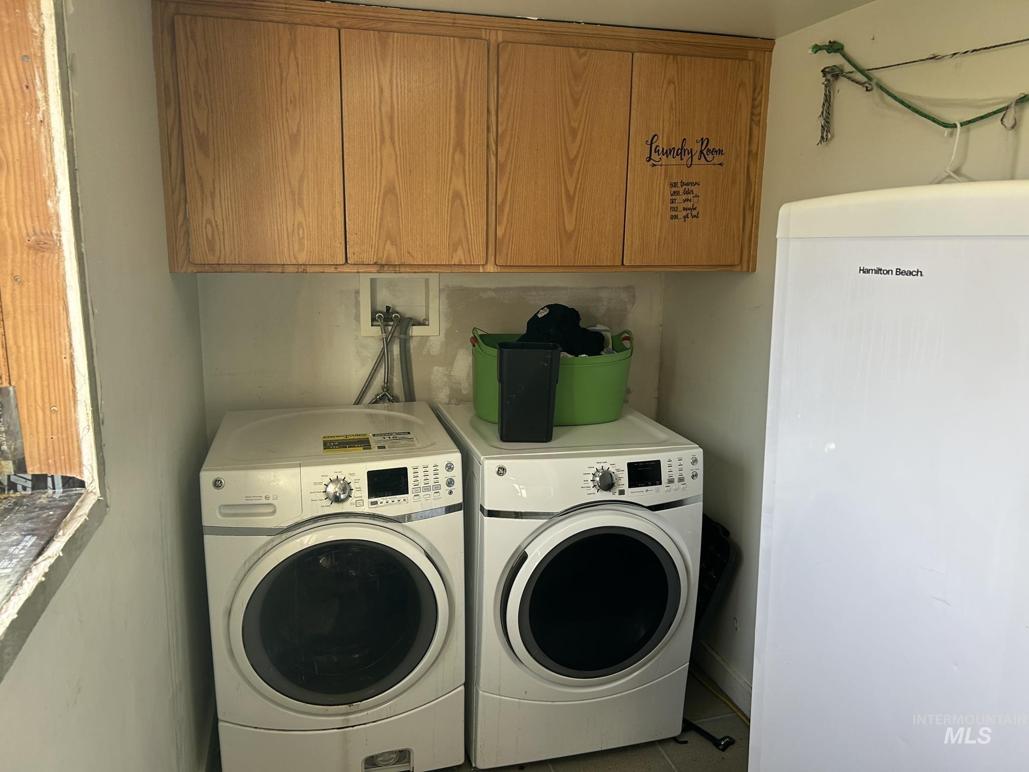 Laundry room with washer and dryer and cabinet space