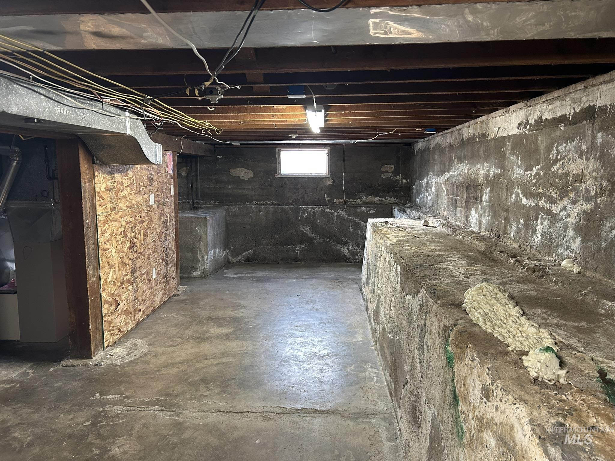 Basement featuring heating unit