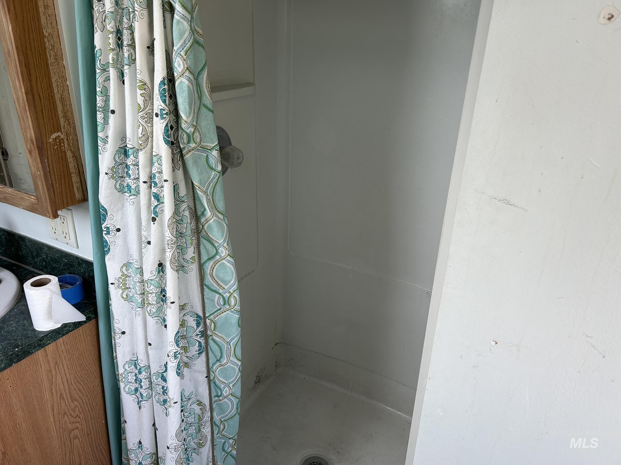 Full bath with a stall shower and vanity