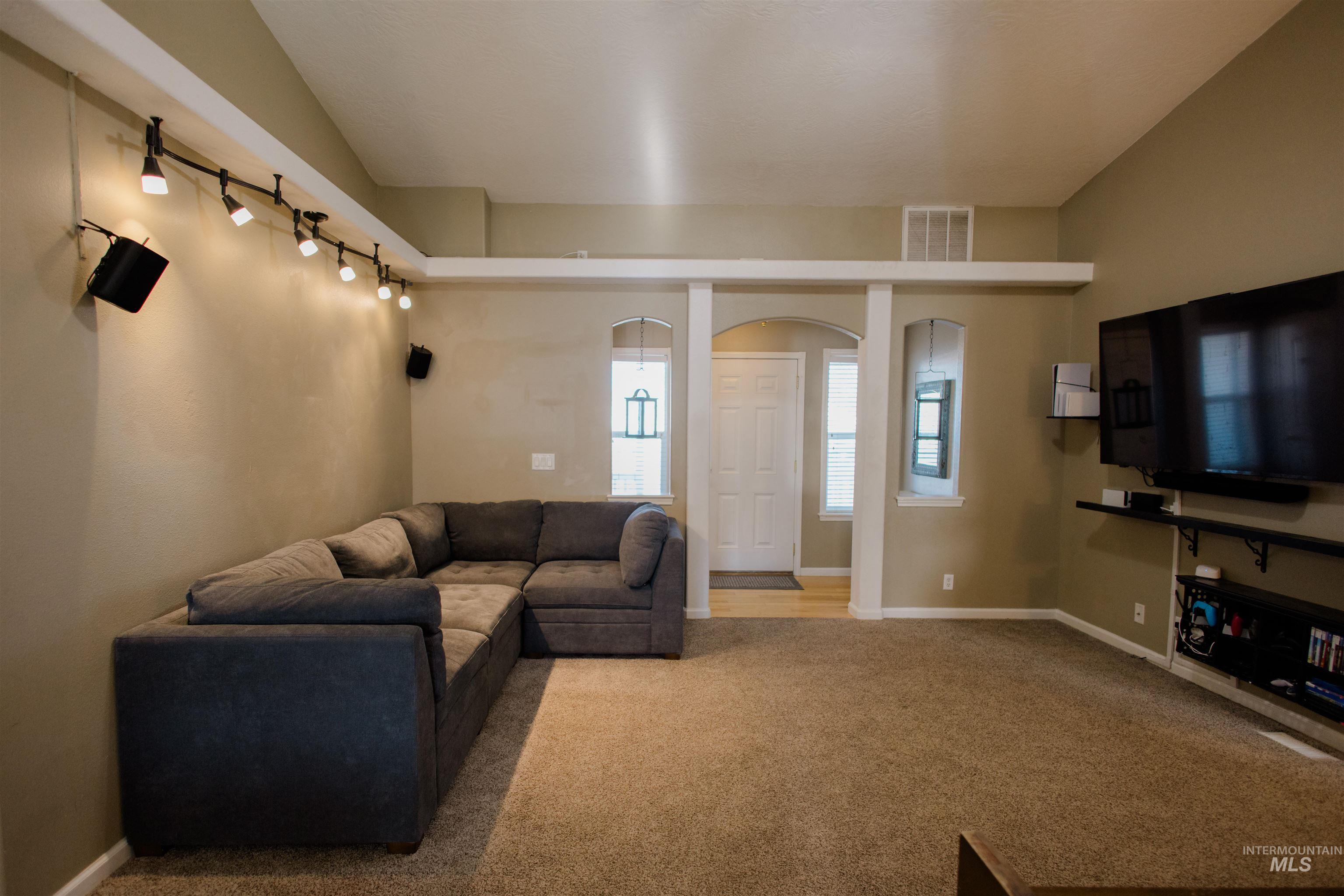Living room featuring carpet flooring and arched walkways