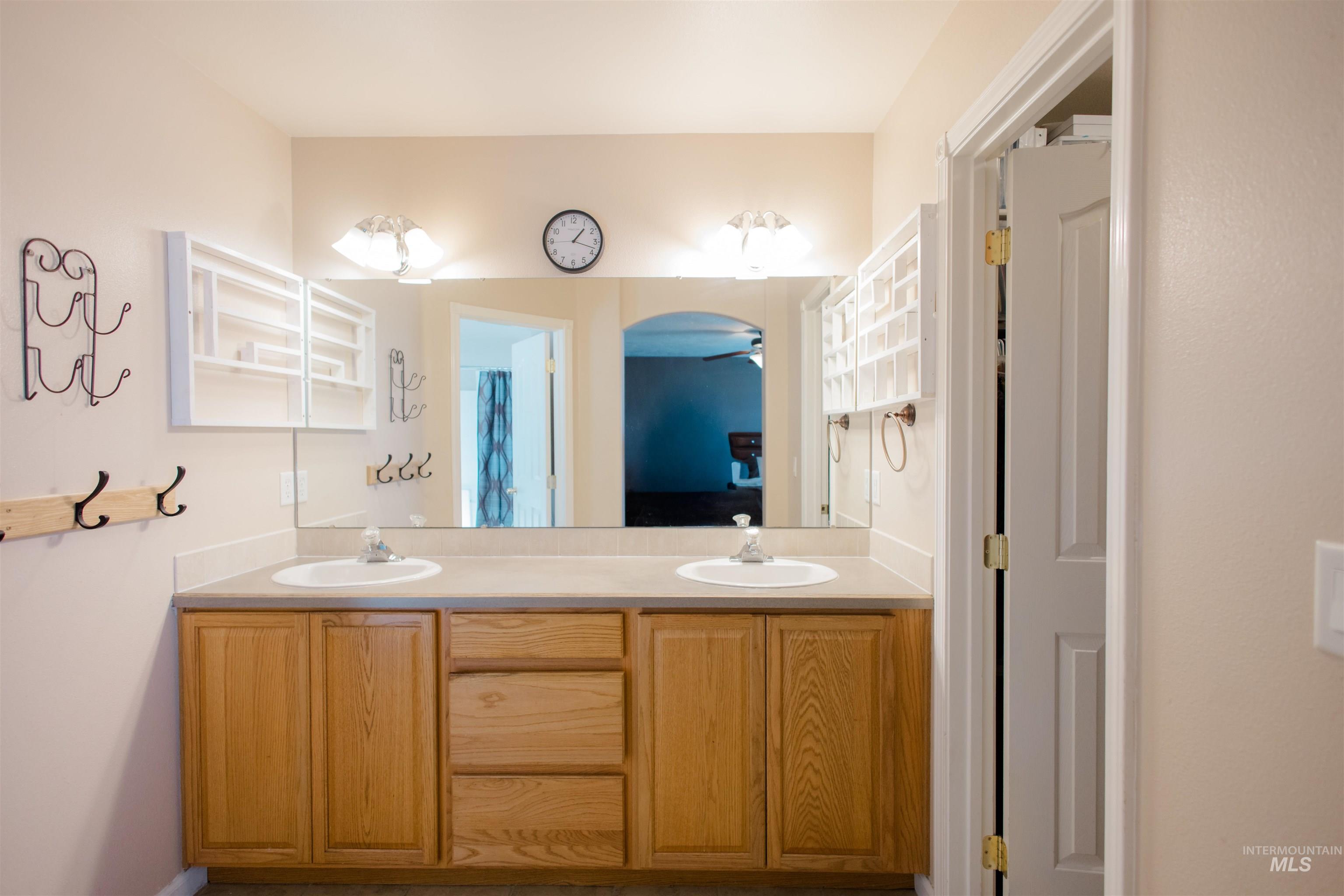 Bathroom featuring double vanity and connected bathroom