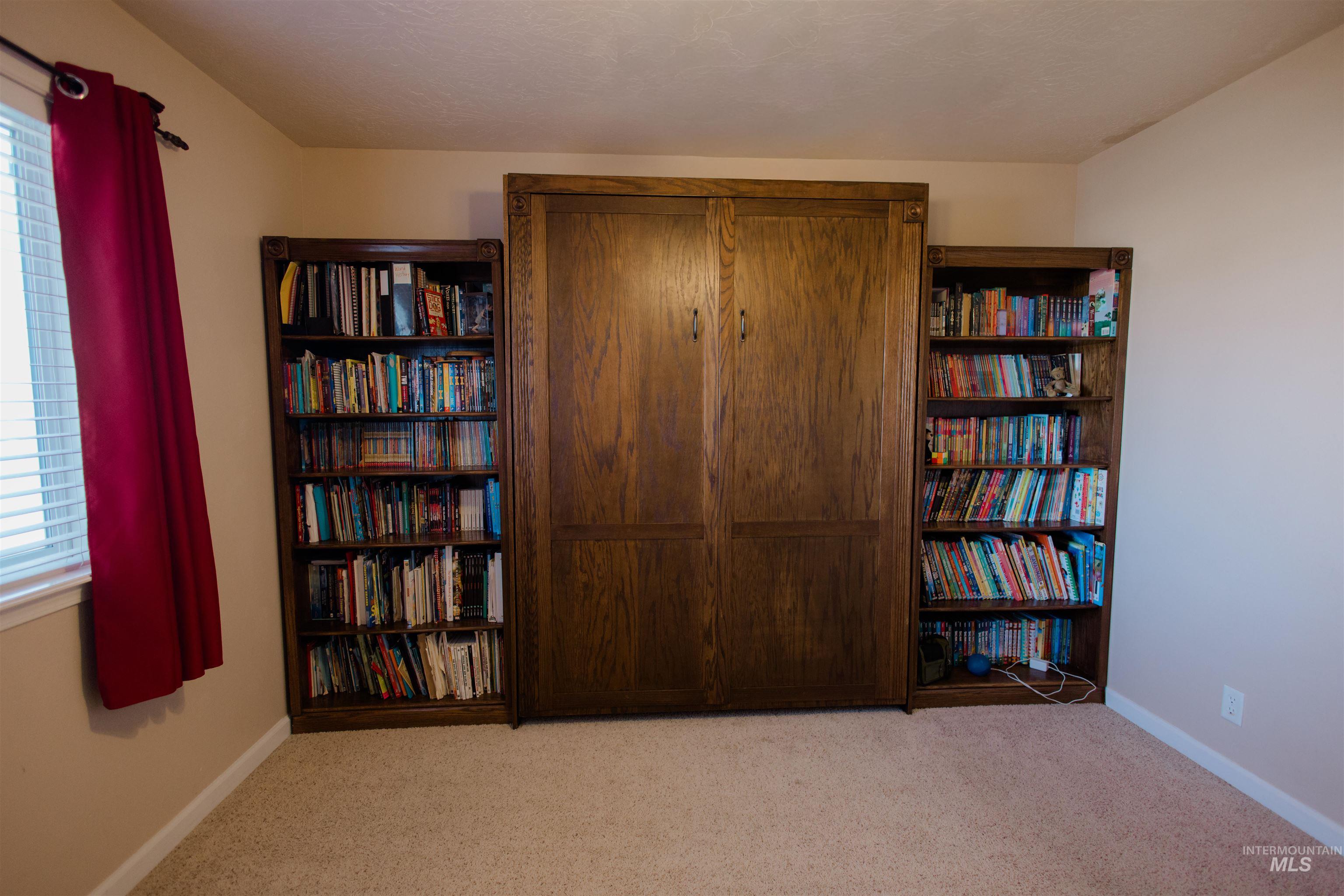 Sitting room with light colored carpet and baseboards