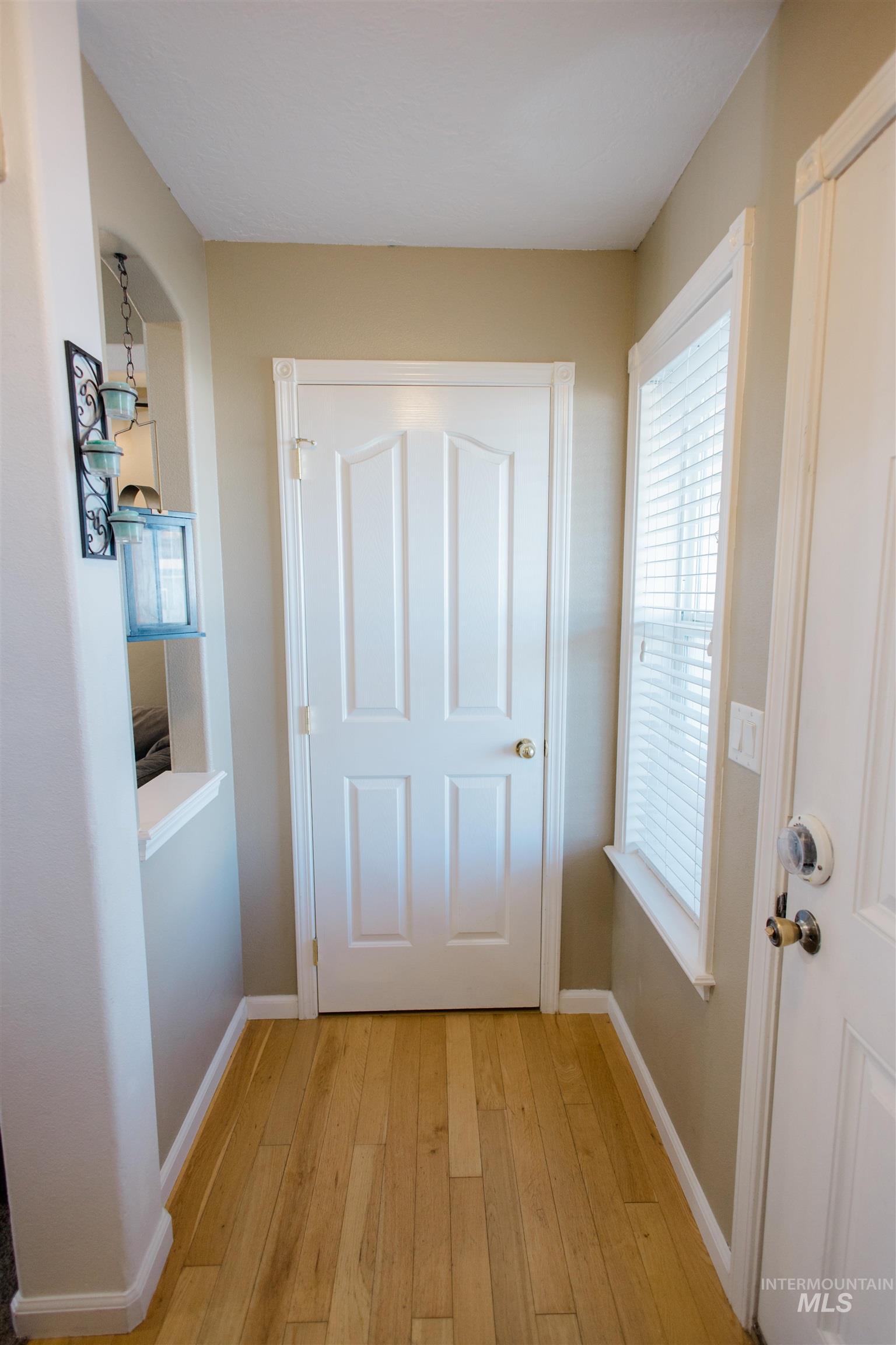 Entryway with hardwood / wood-style flooring and plenty of natural light