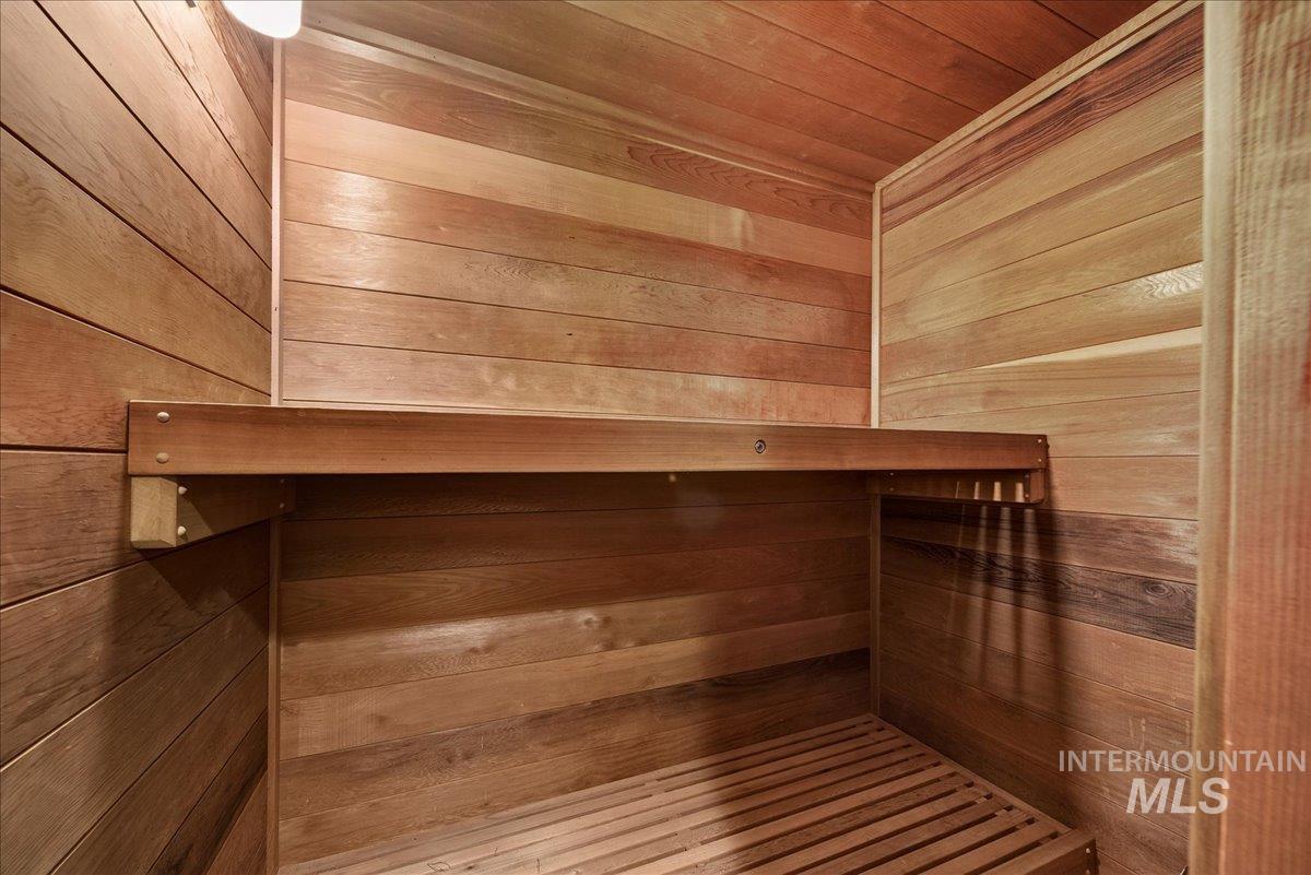 Sauna featuring wood ceiling and wooden walls