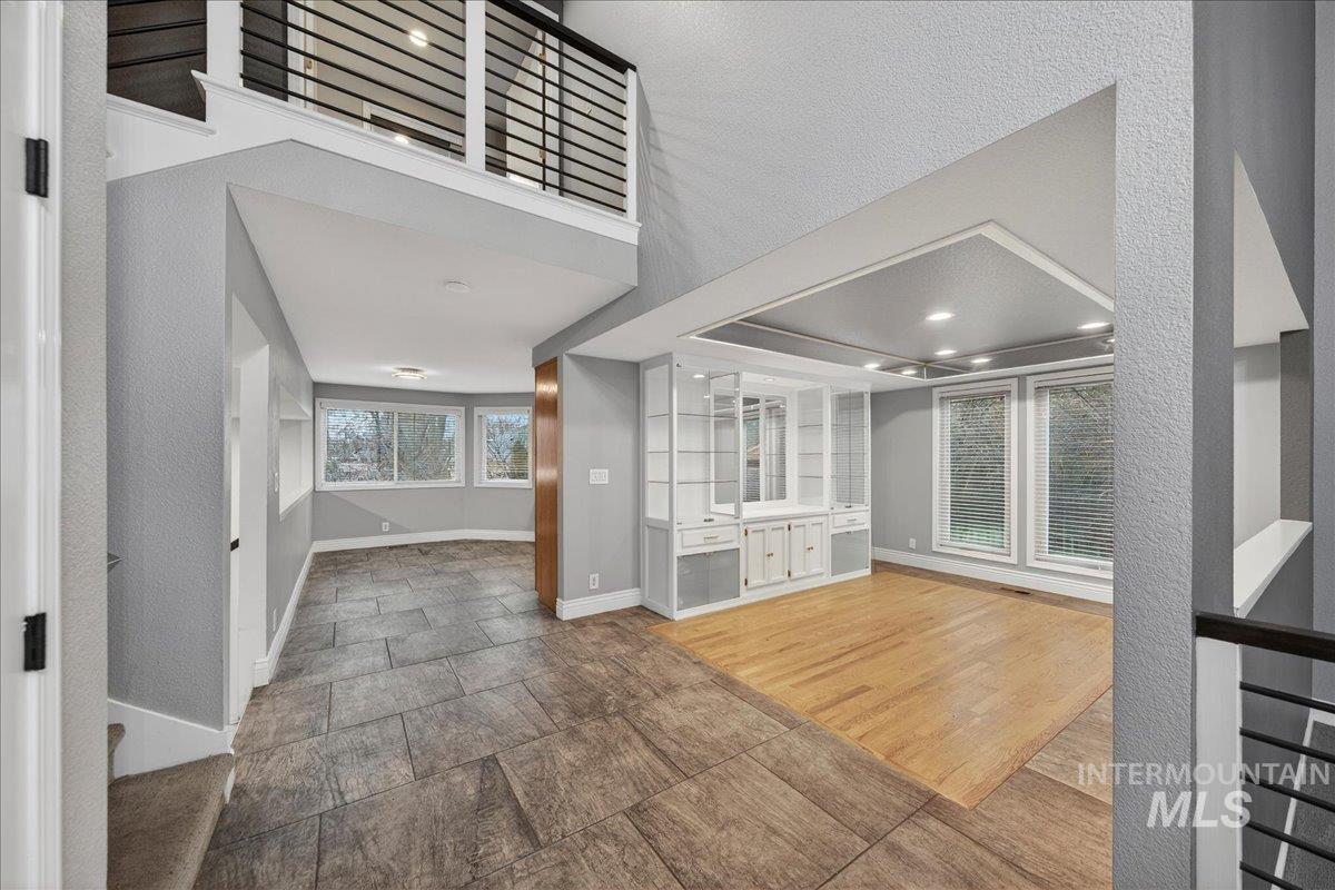 Foyer entrance with baseboards and a textured wall