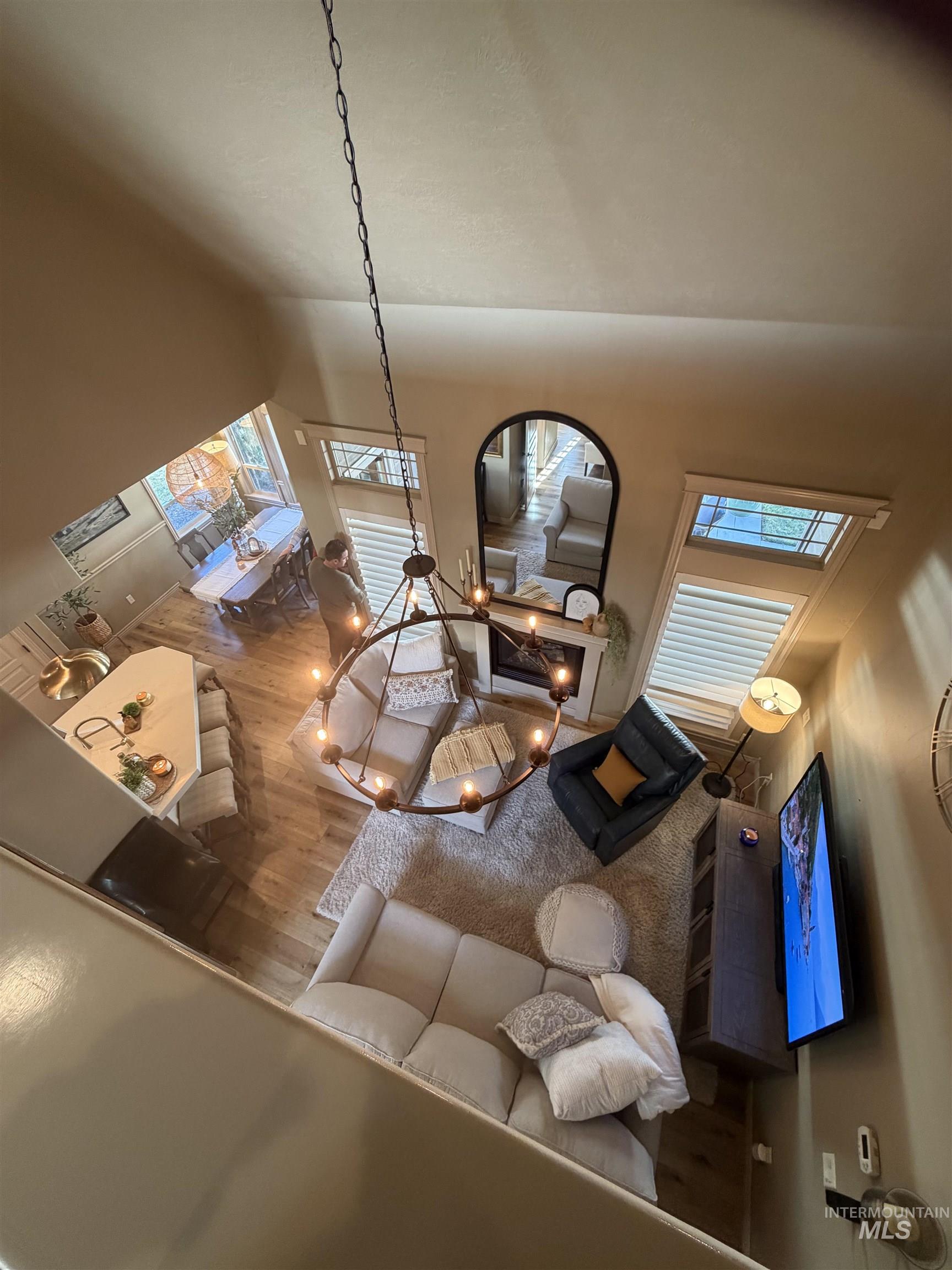 Detailed view of wood finished floors and a chandelier