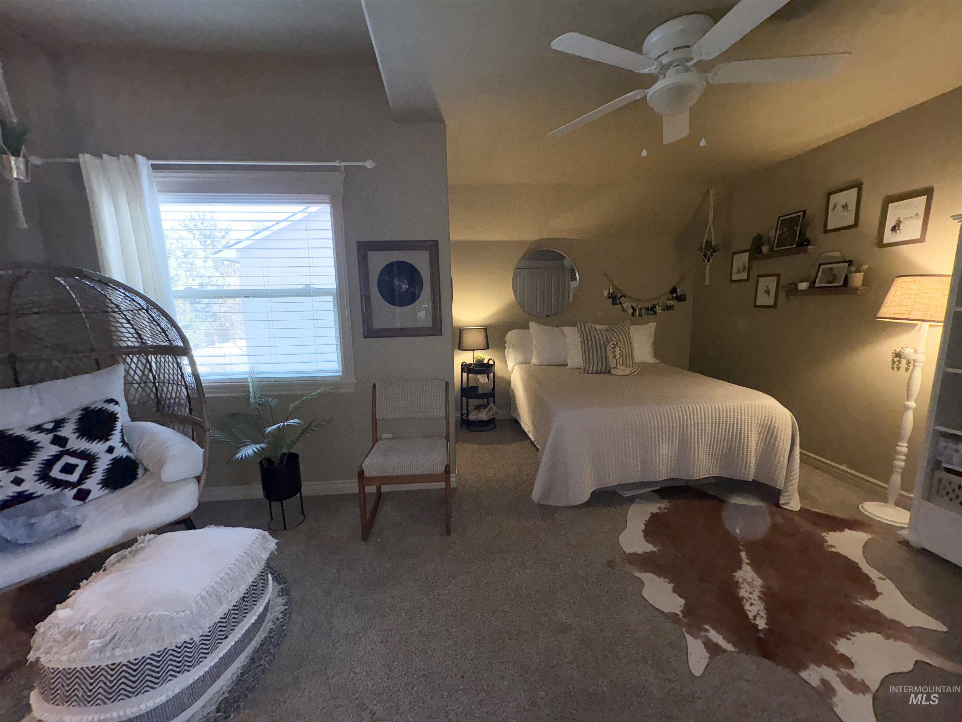 Carpeted bedroom with baseboards and ceiling fan