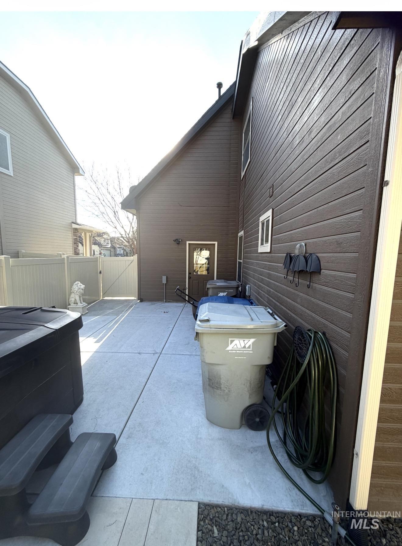 View of patio / terrace featuring a gate and a hot tub