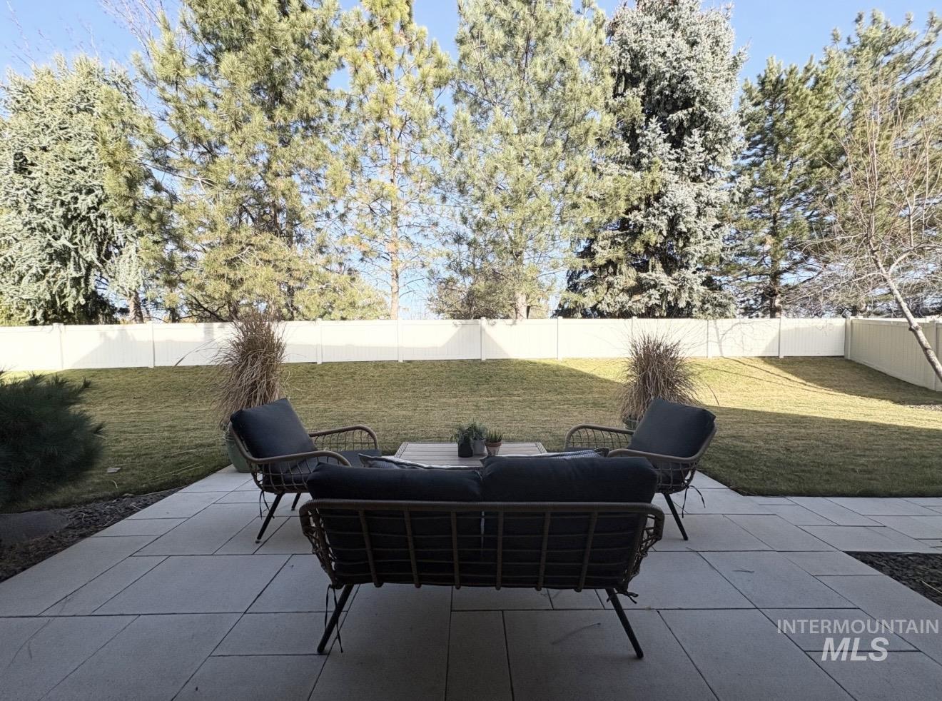 Fenced backyard featuring a patio