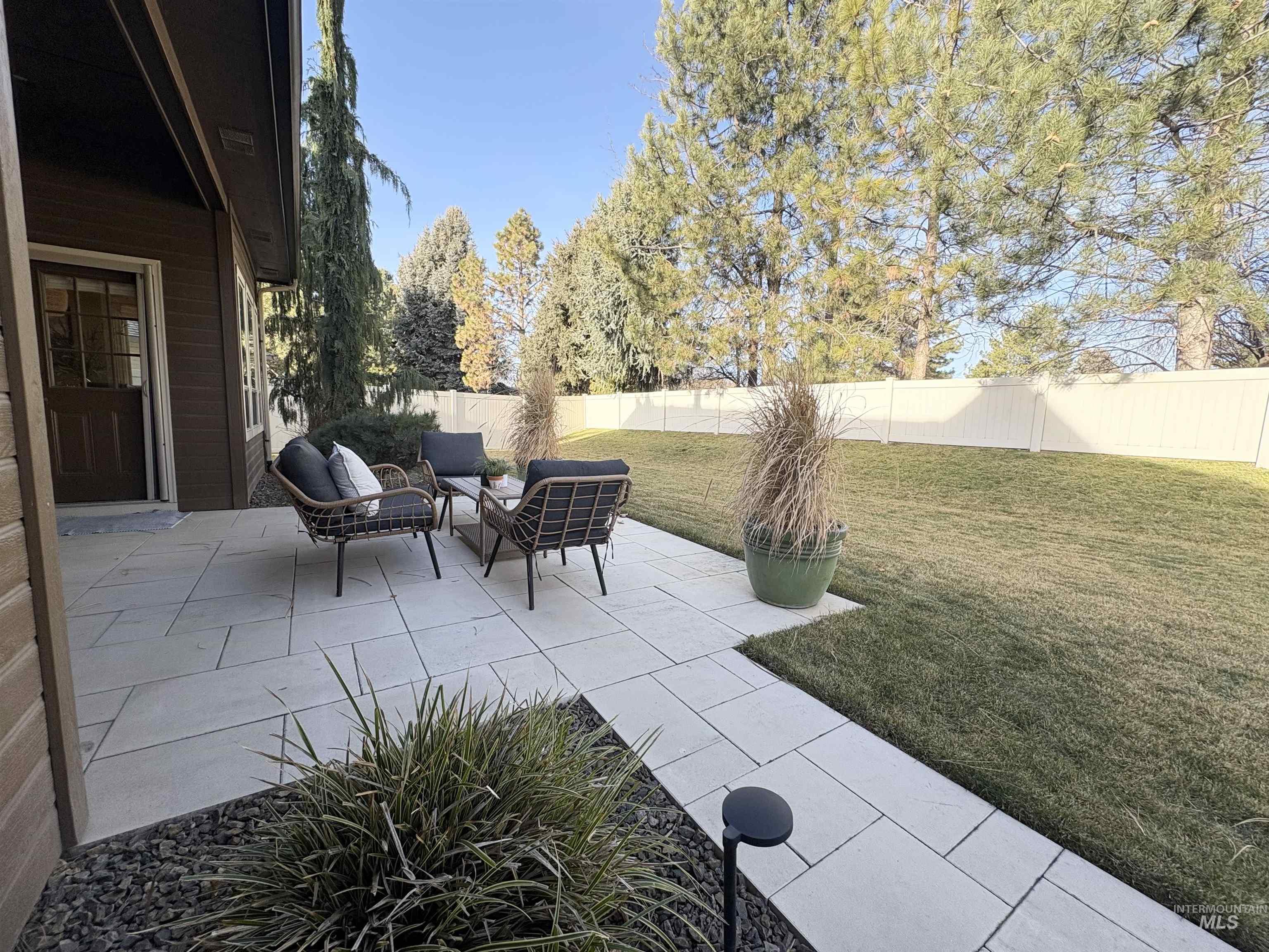 Fenced backyard with a patio area and outdoor lounge area