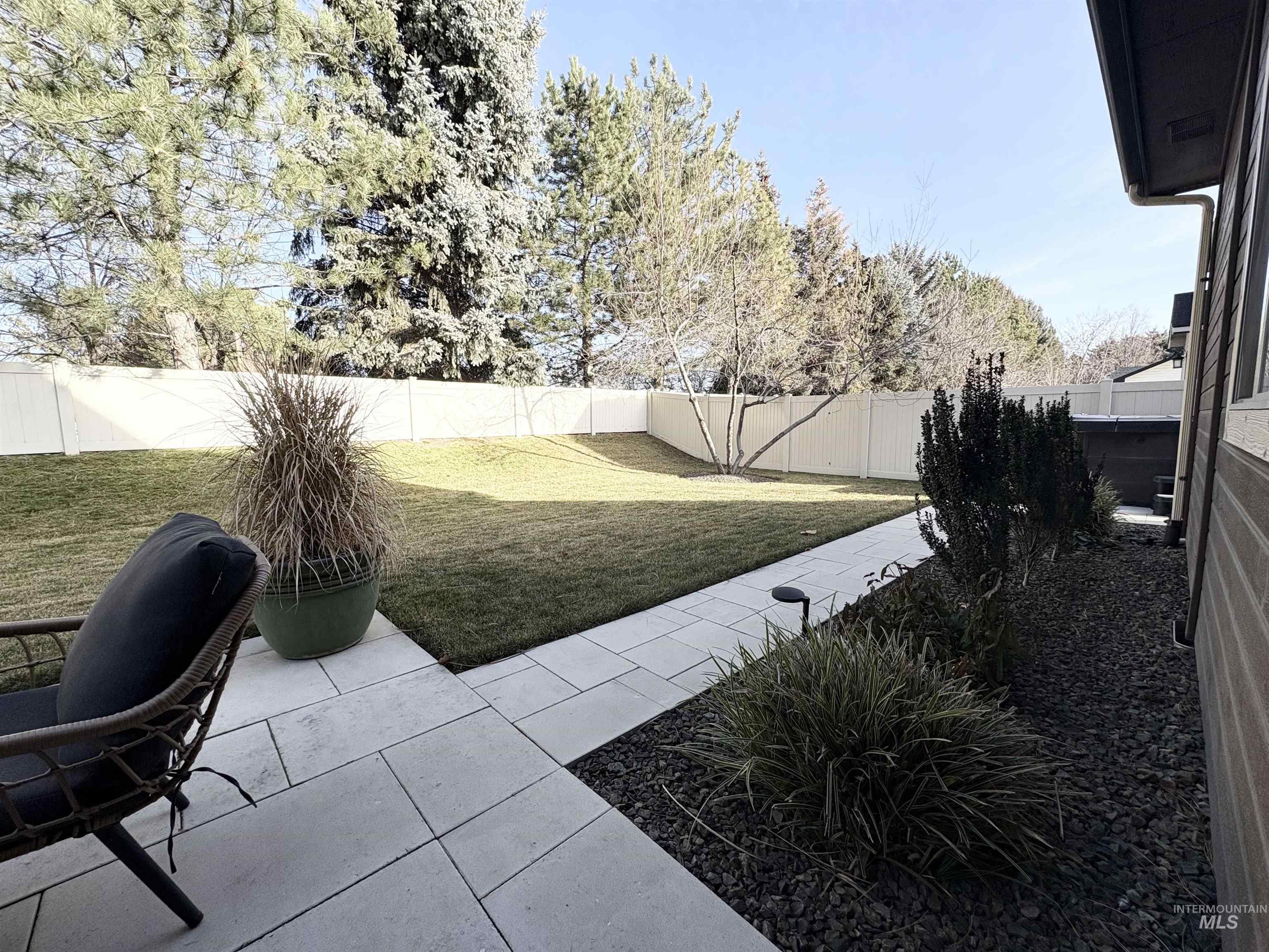 Fenced backyard with a patio