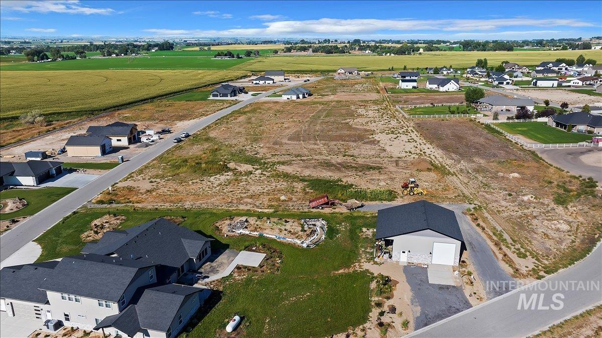 Aerial view of property's location with nearby suburban area and rural landscape