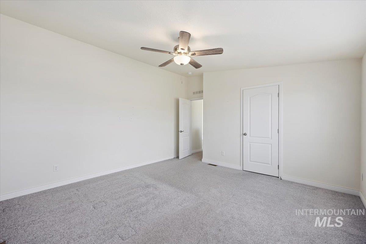 Unfurnished bedroom featuring carpet and ceiling fan