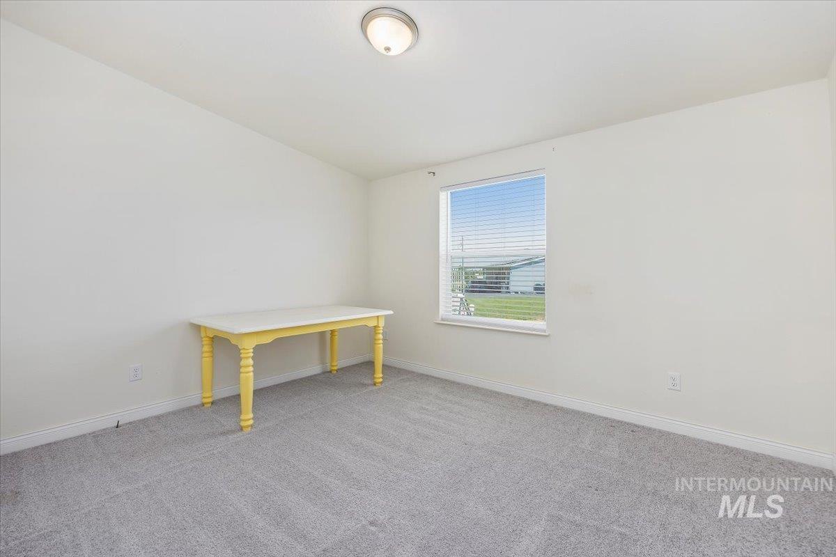 Unfurnished room with baseboards and carpet flooring