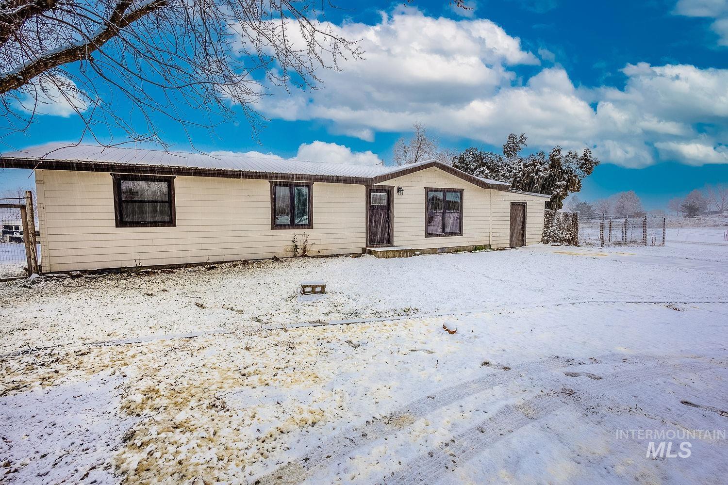 Ranch-style house featuring a gate