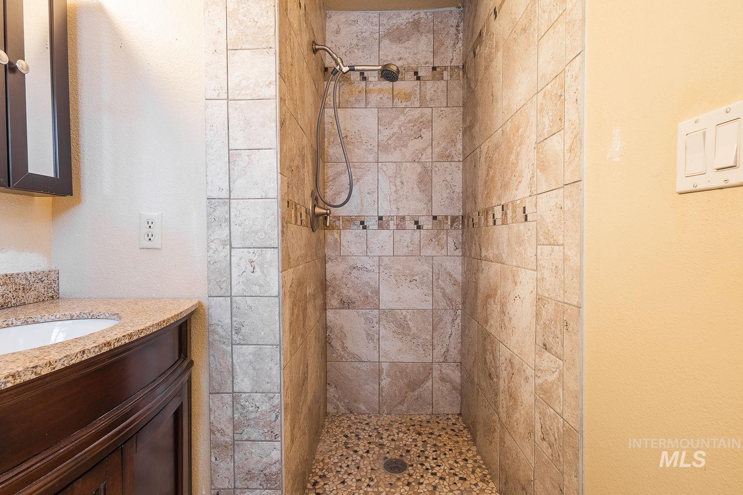 Bathroom with a stall shower and vanity