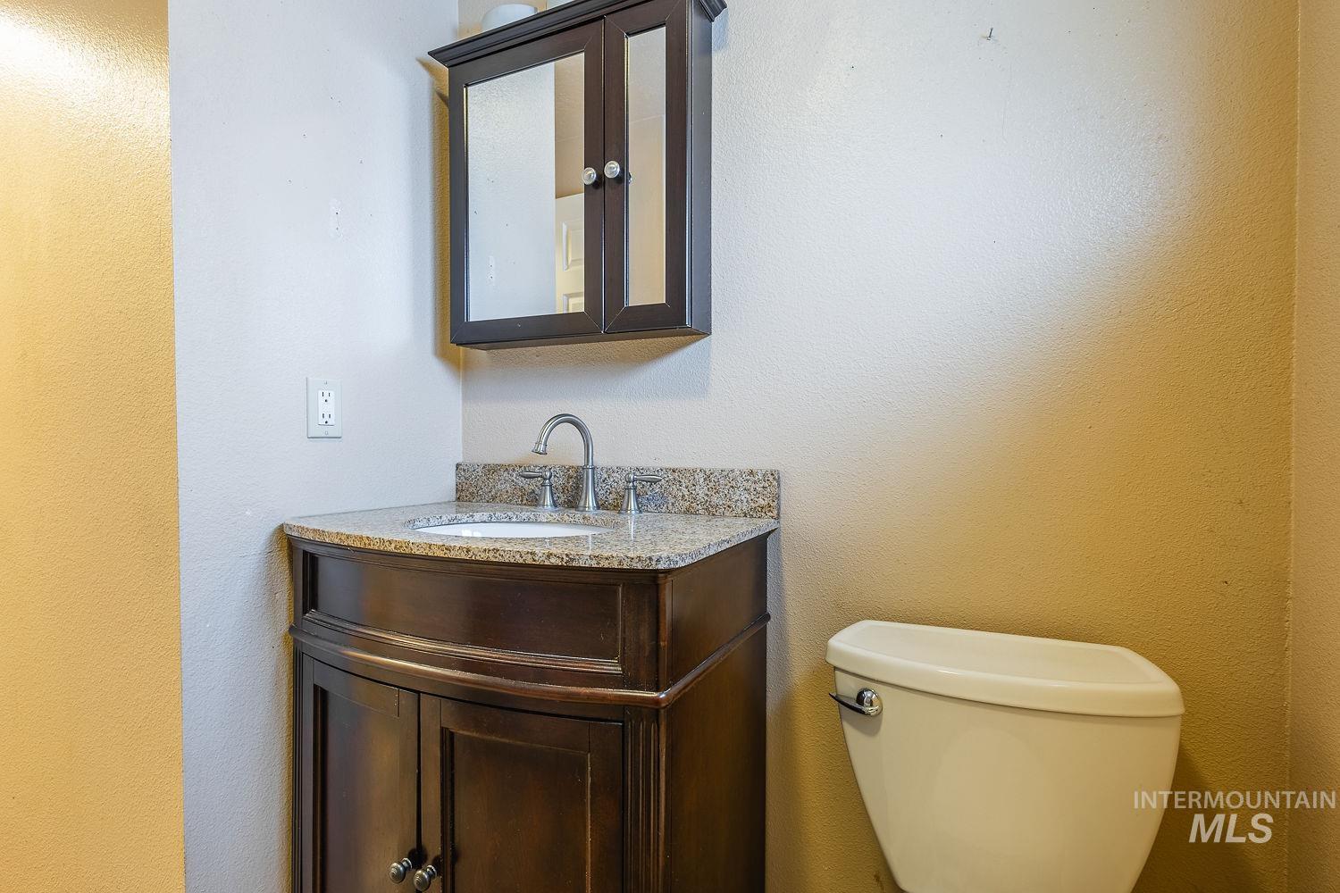 Bathroom with a textured wall and vanity