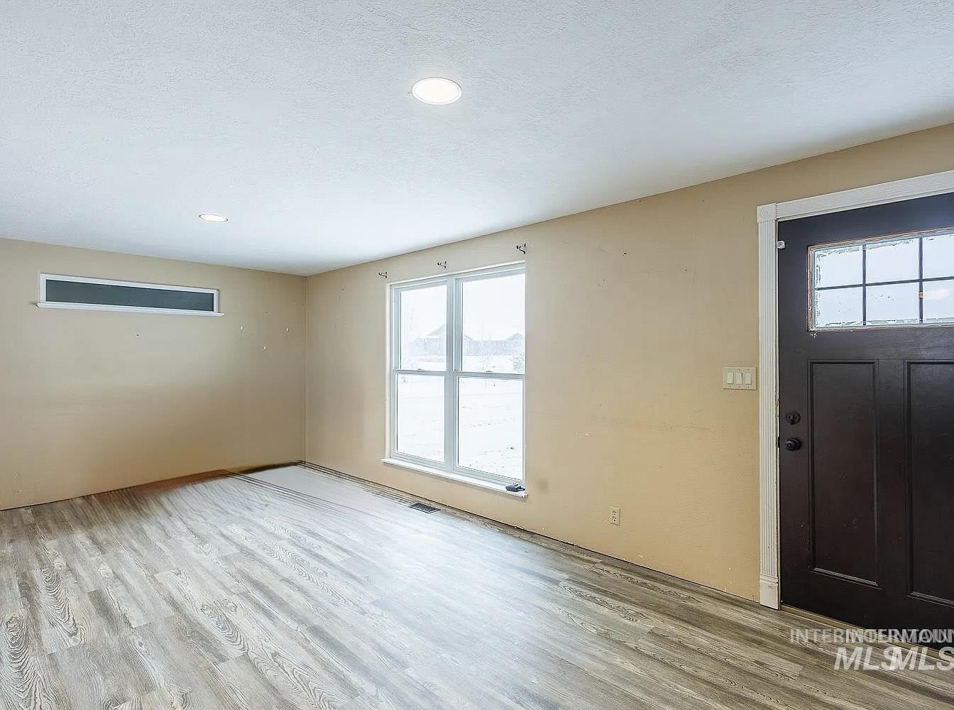 Entrance foyer featuring light wood-style floors, a textured ceiling, and recessed lighting