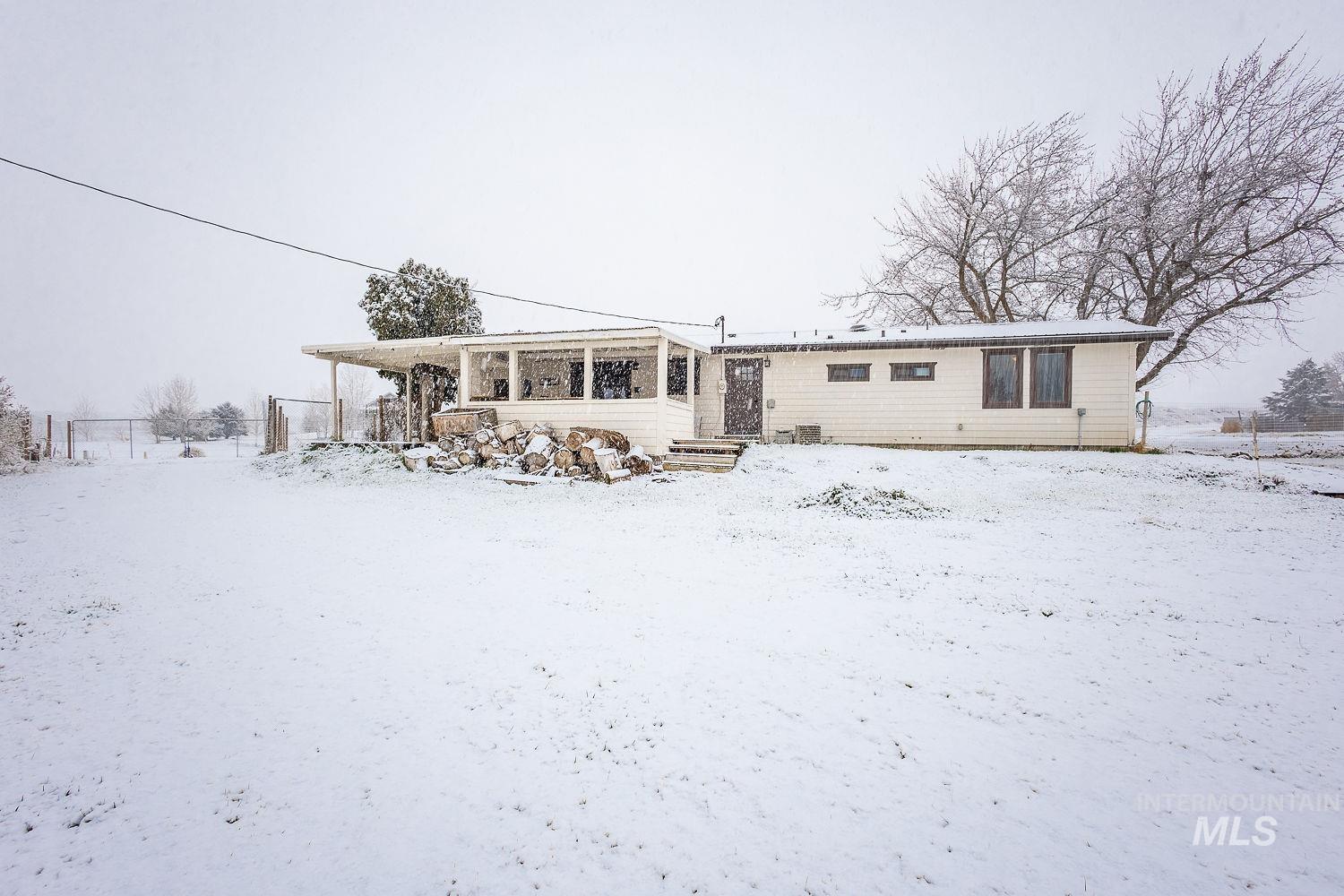 Snow covered property featuring a patio