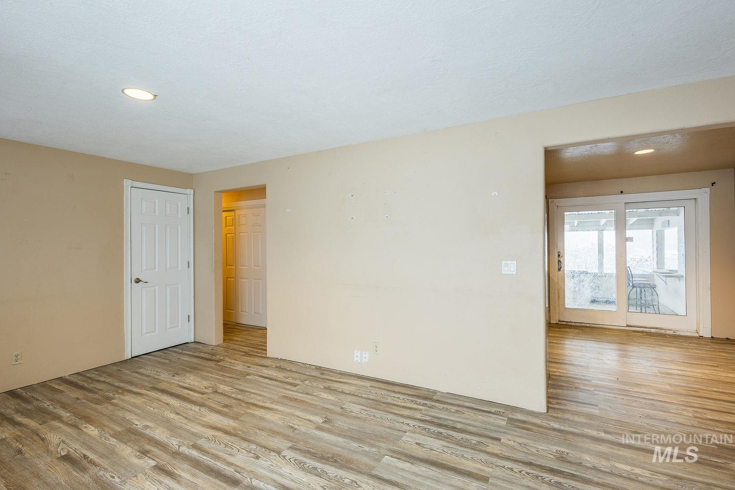 Empty room with recessed lighting and light wood-style floors