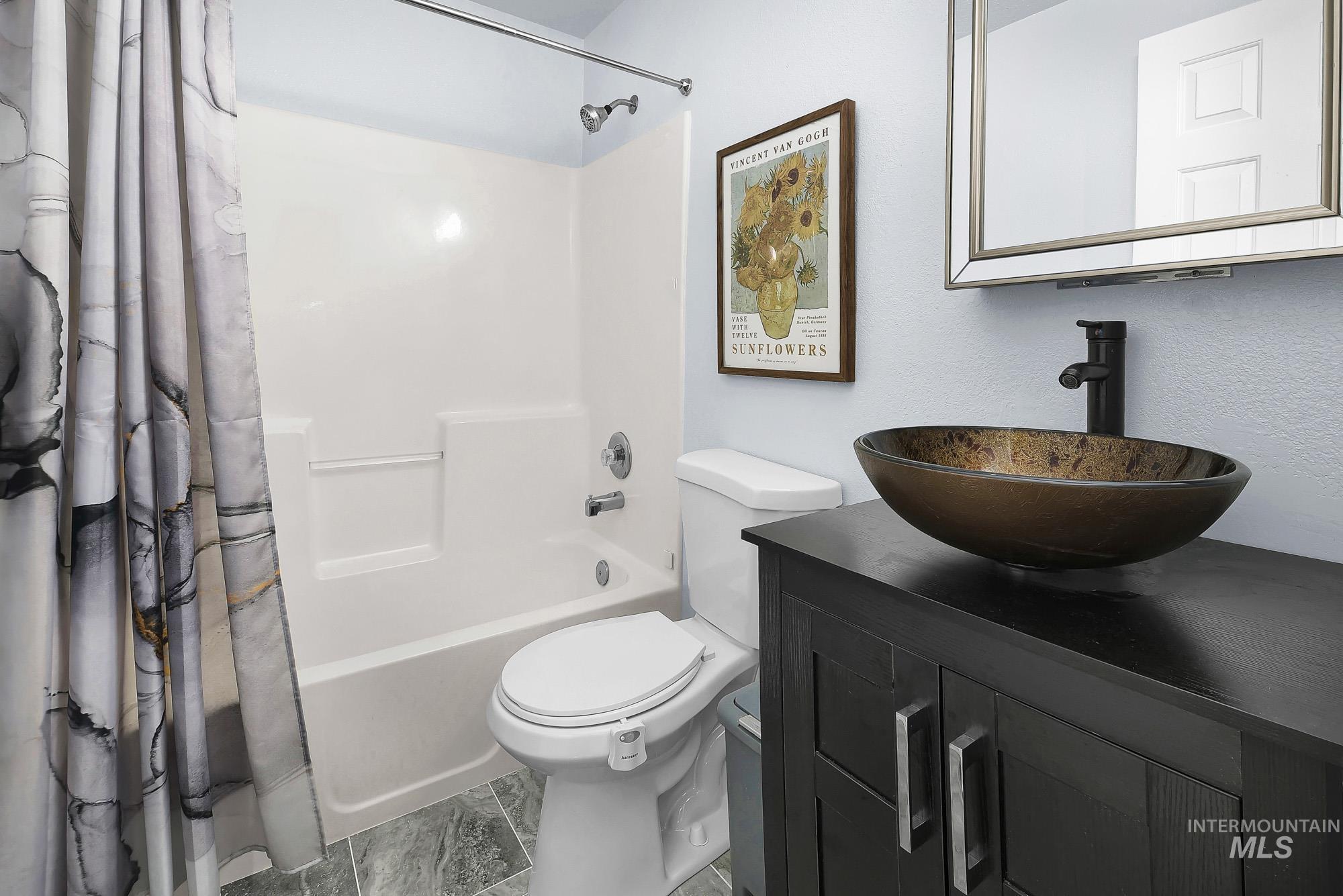 Bathroom with shower / bath combo and vanity