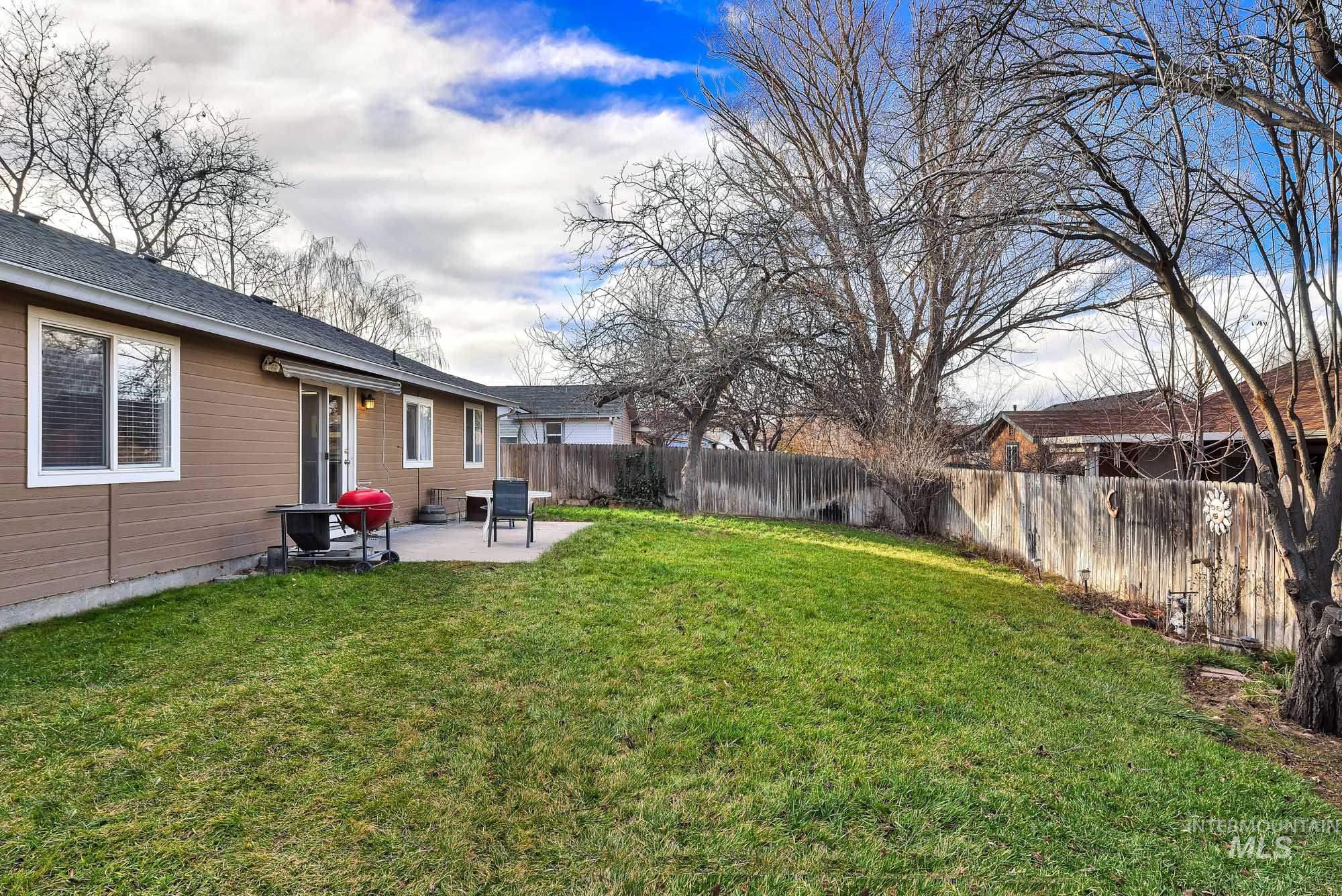 Fenced backyard with a patio