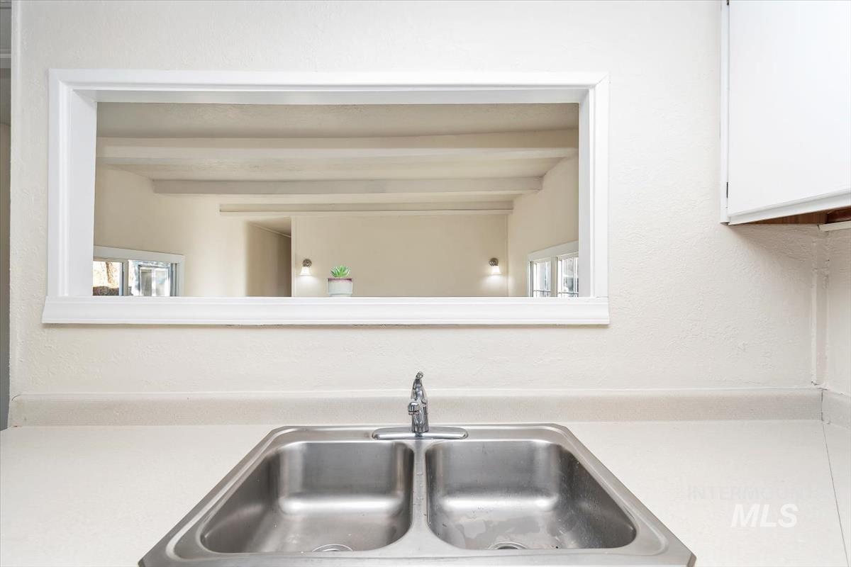 Kitchen view of light countertops and white cabinets