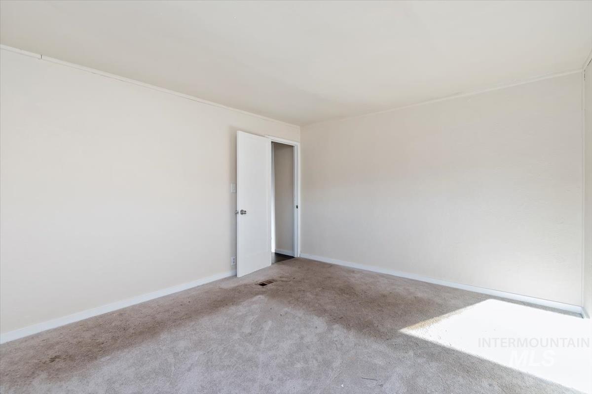 Unfurnished room with baseboards and carpet flooring