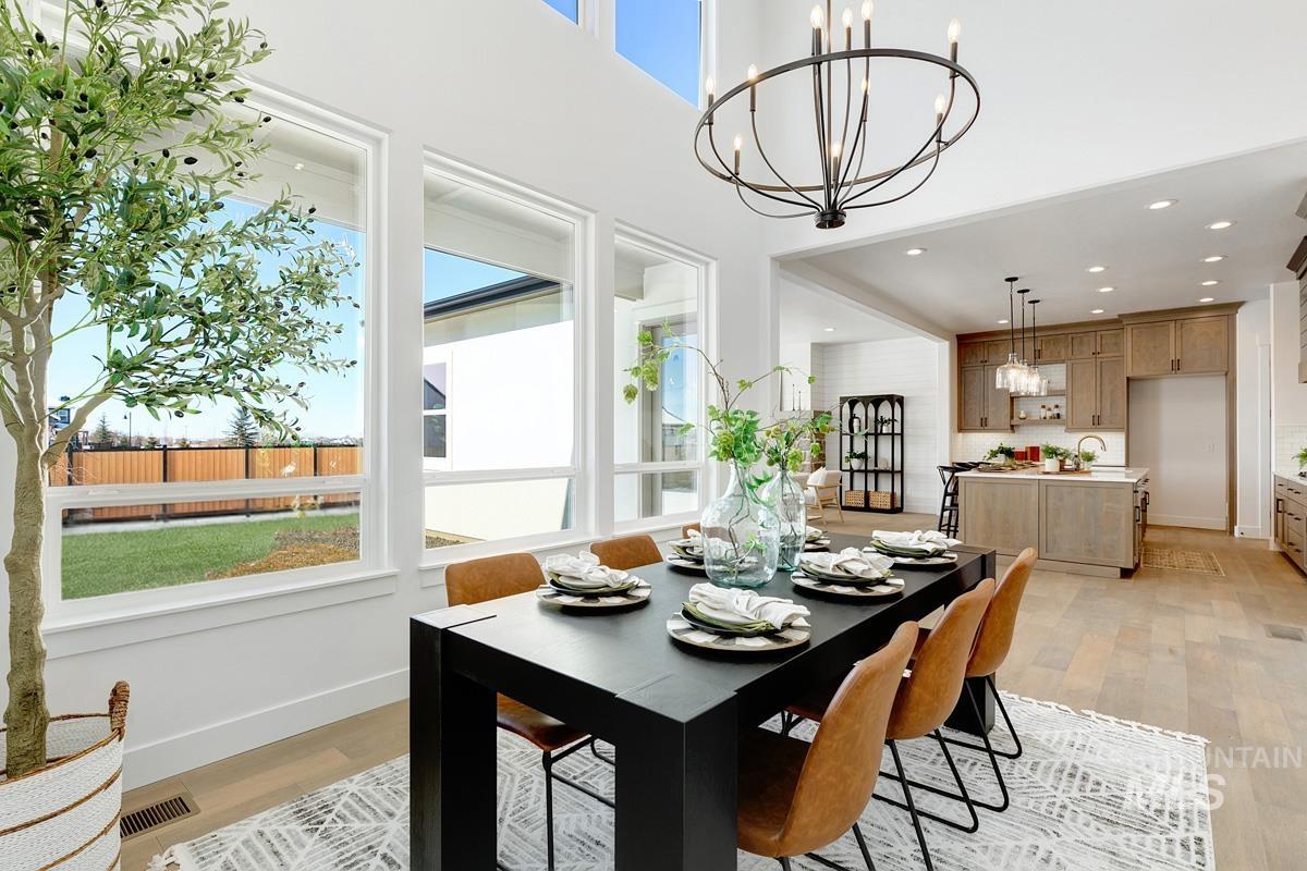 Dining room featuring healthy amount of natural light, recessed lighting, light wood-style flooring, and a chandelier
