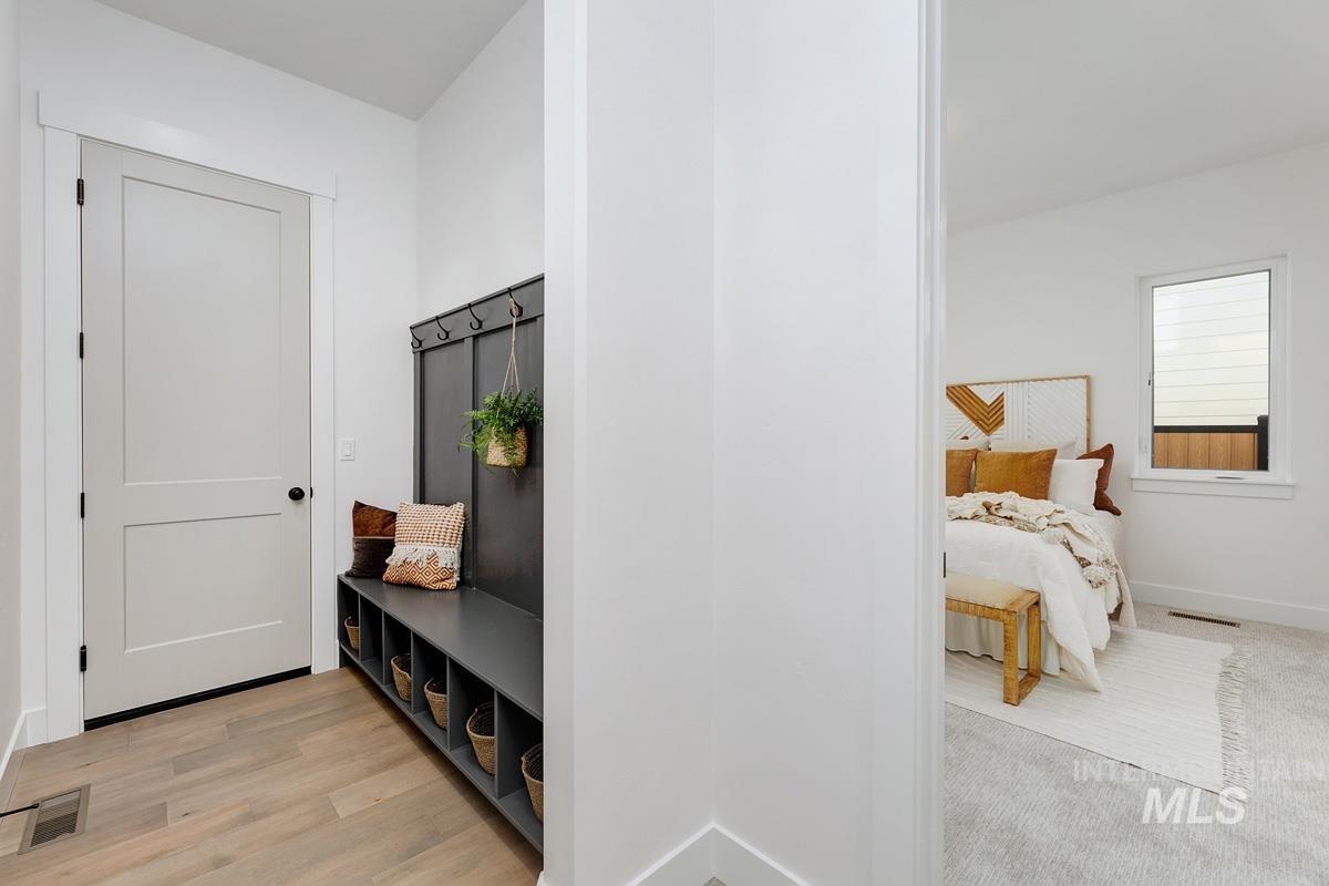 Mudroom with baseboards and light wood-type flooring
