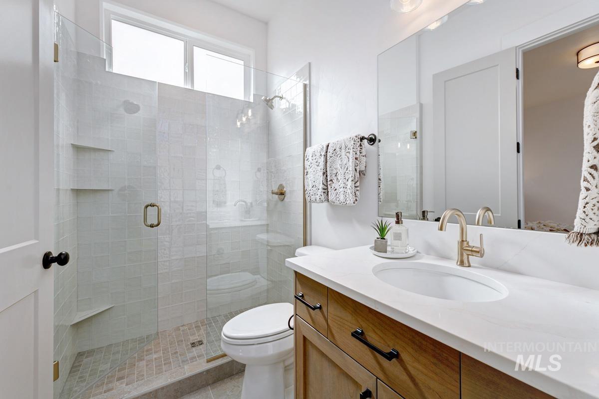 Full bathroom featuring vanity and a stall shower